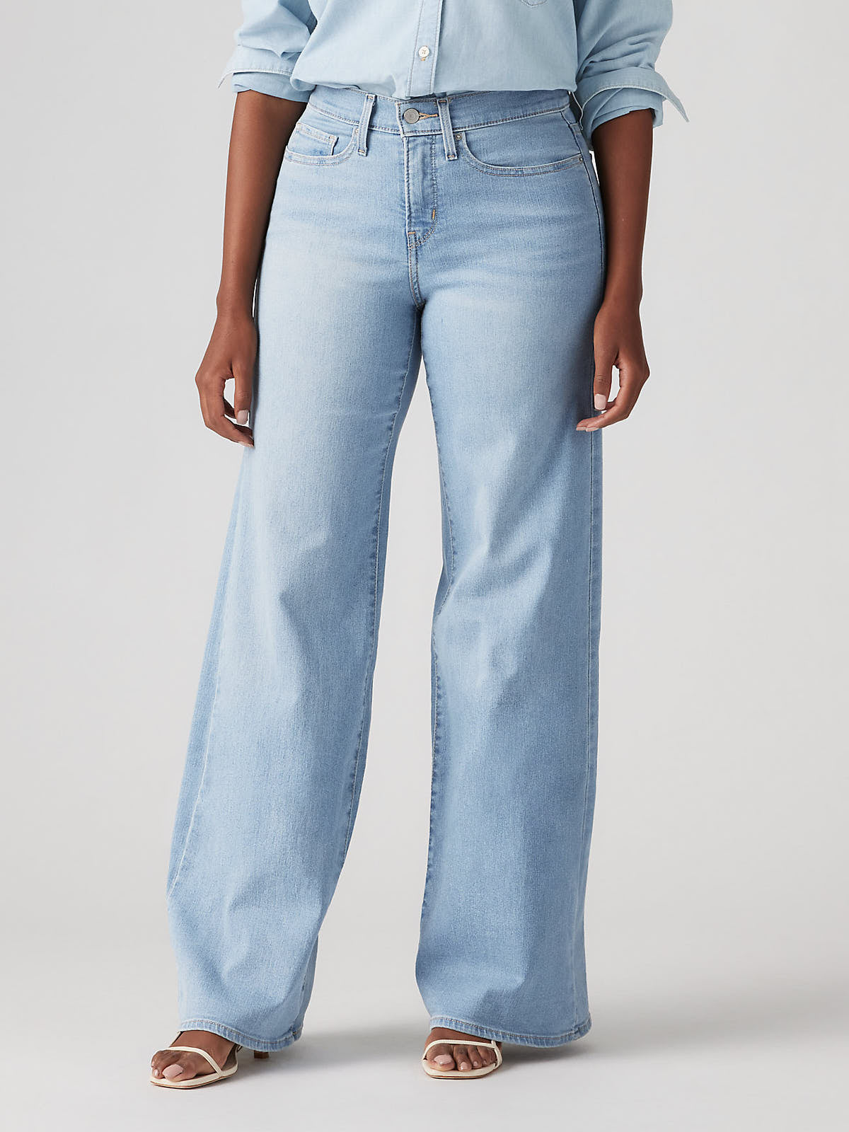 Light wash denim Levi’s 318 Shaping Tall Glass of Water Wide Jeans by Levi Strauss & Co with wide leg silhouette.