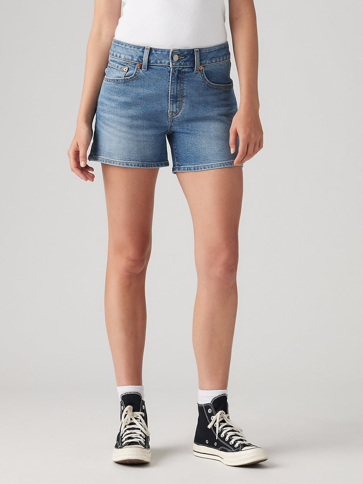 Levi’s A-Line No You Didn’t Denim Short in classic blue wash by Levi Strauss & Co styled with black high-top sneakers
