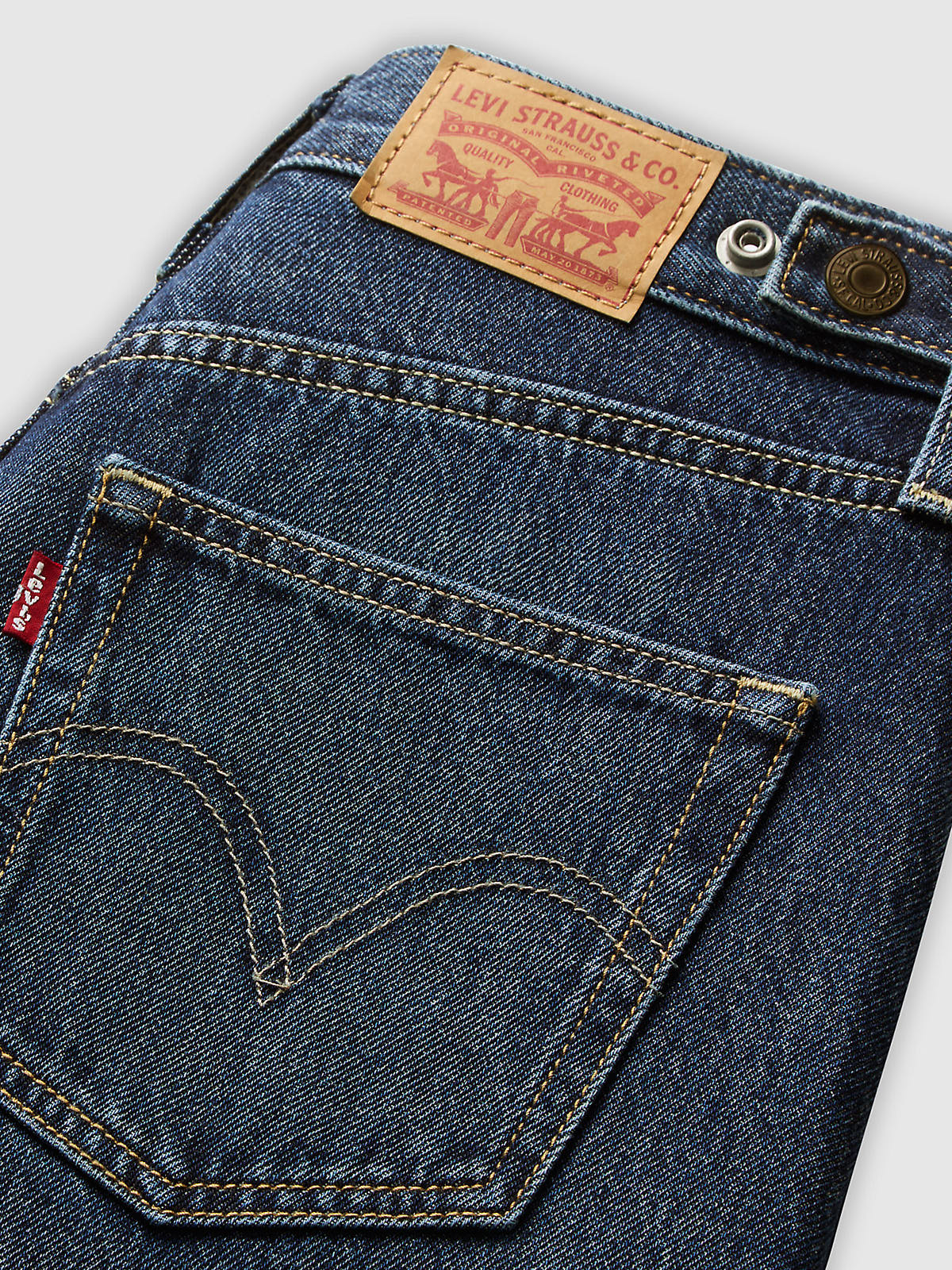 Close-up of Levi’s Cinch Barrel New Shades Denim Jeans back pocket with Levi Strauss & Co leather patch on dark blue denim