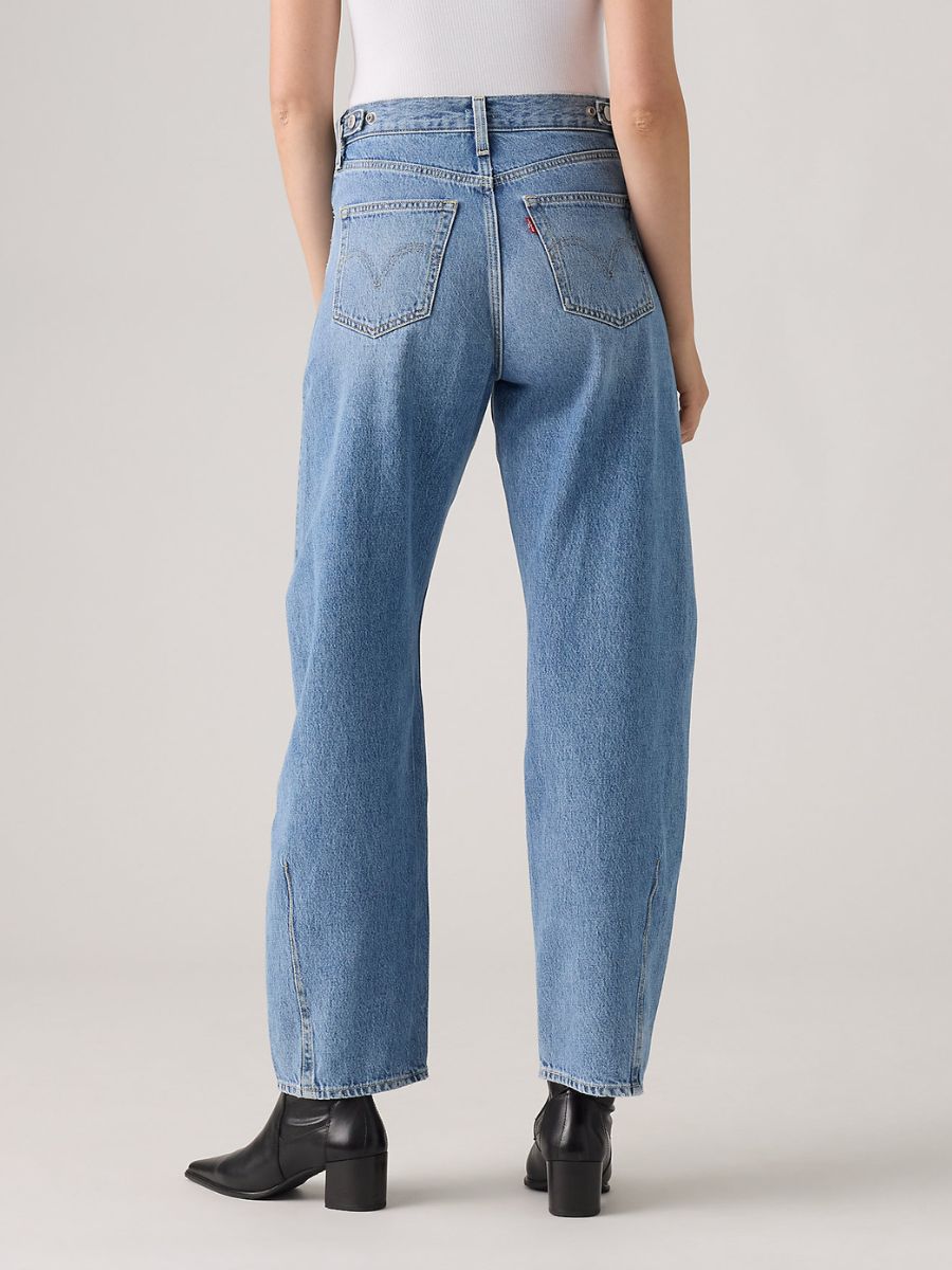 Light blue denim jeans with rear pockets and straight legs paired with black heeled ankle boots.