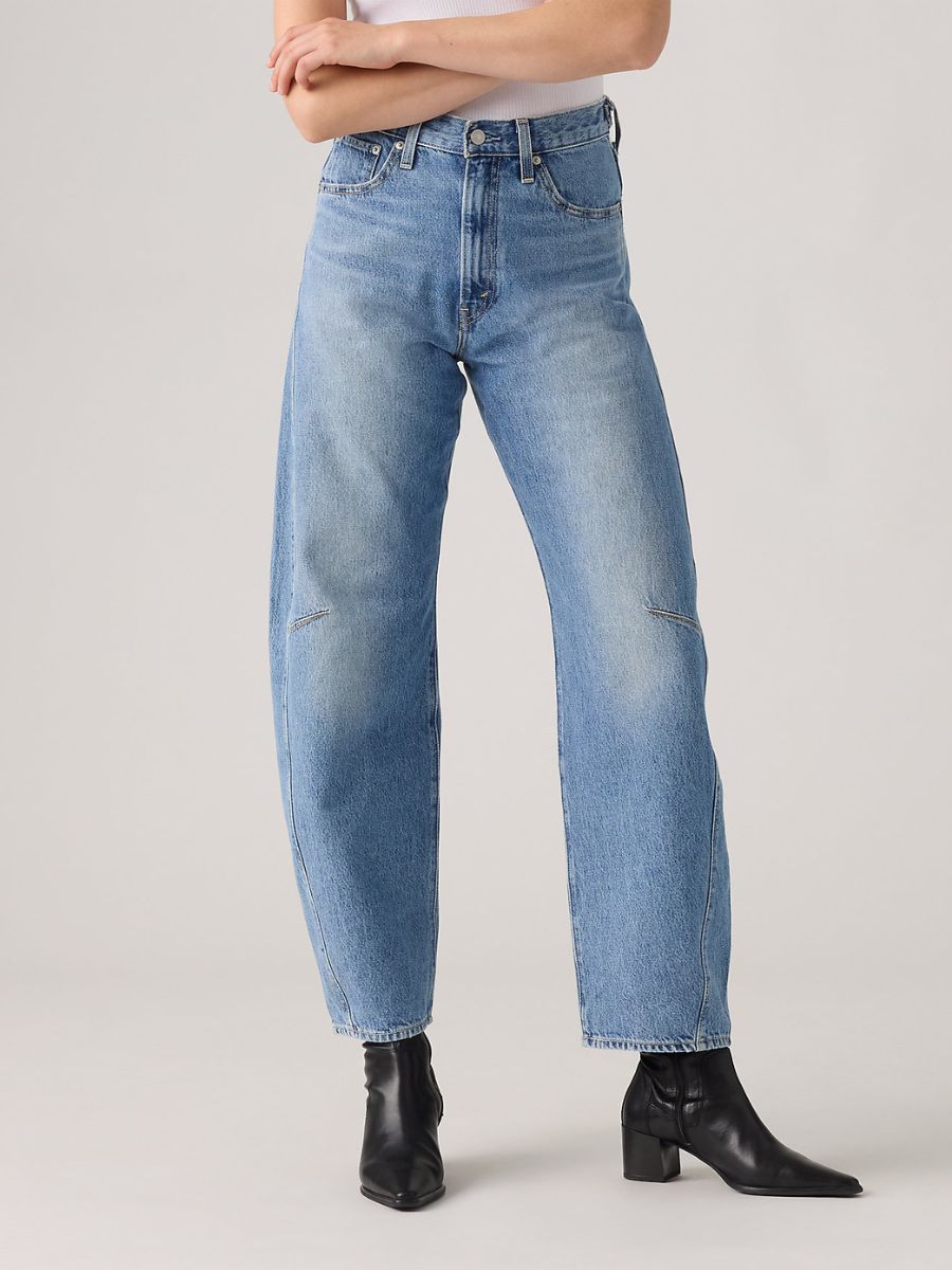 Light blue denim jeans with a high waist and straight leg, paired with black pointed-toe ankle boots.