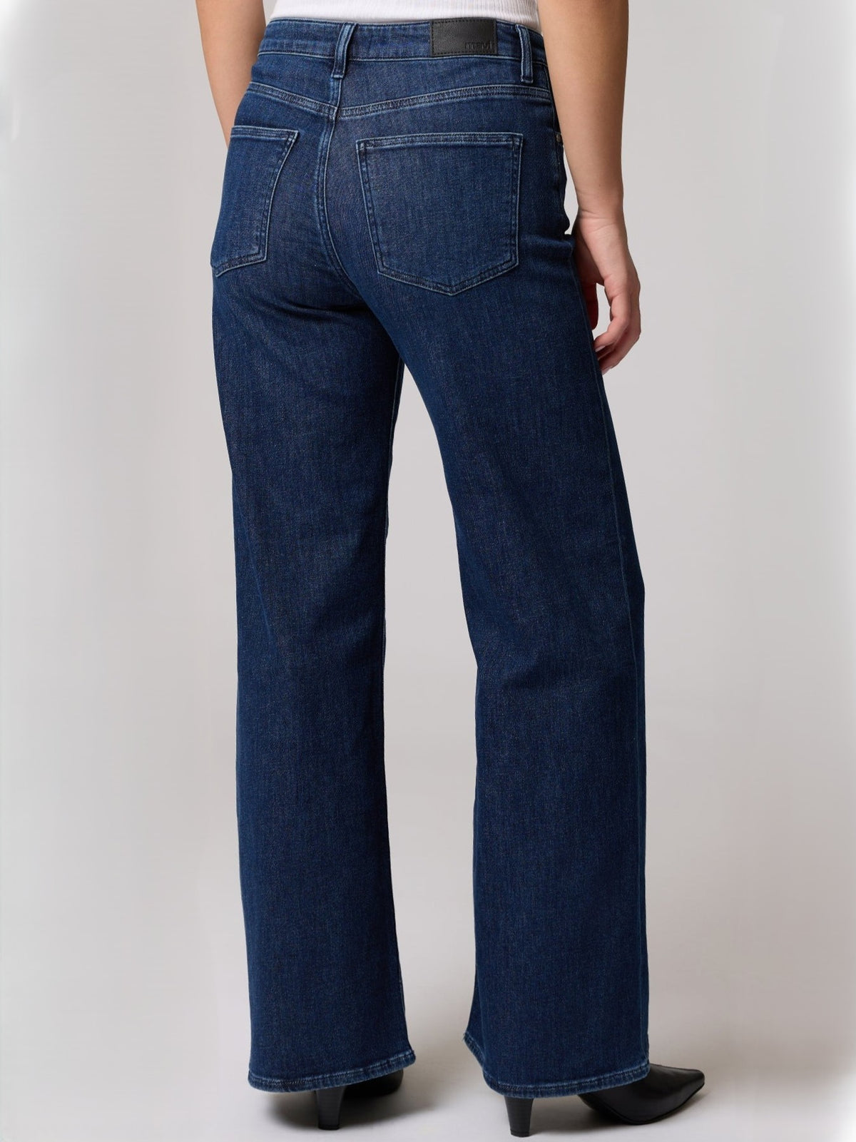 Back view of dark blue wide-leg denim jeans with five-pocket styling