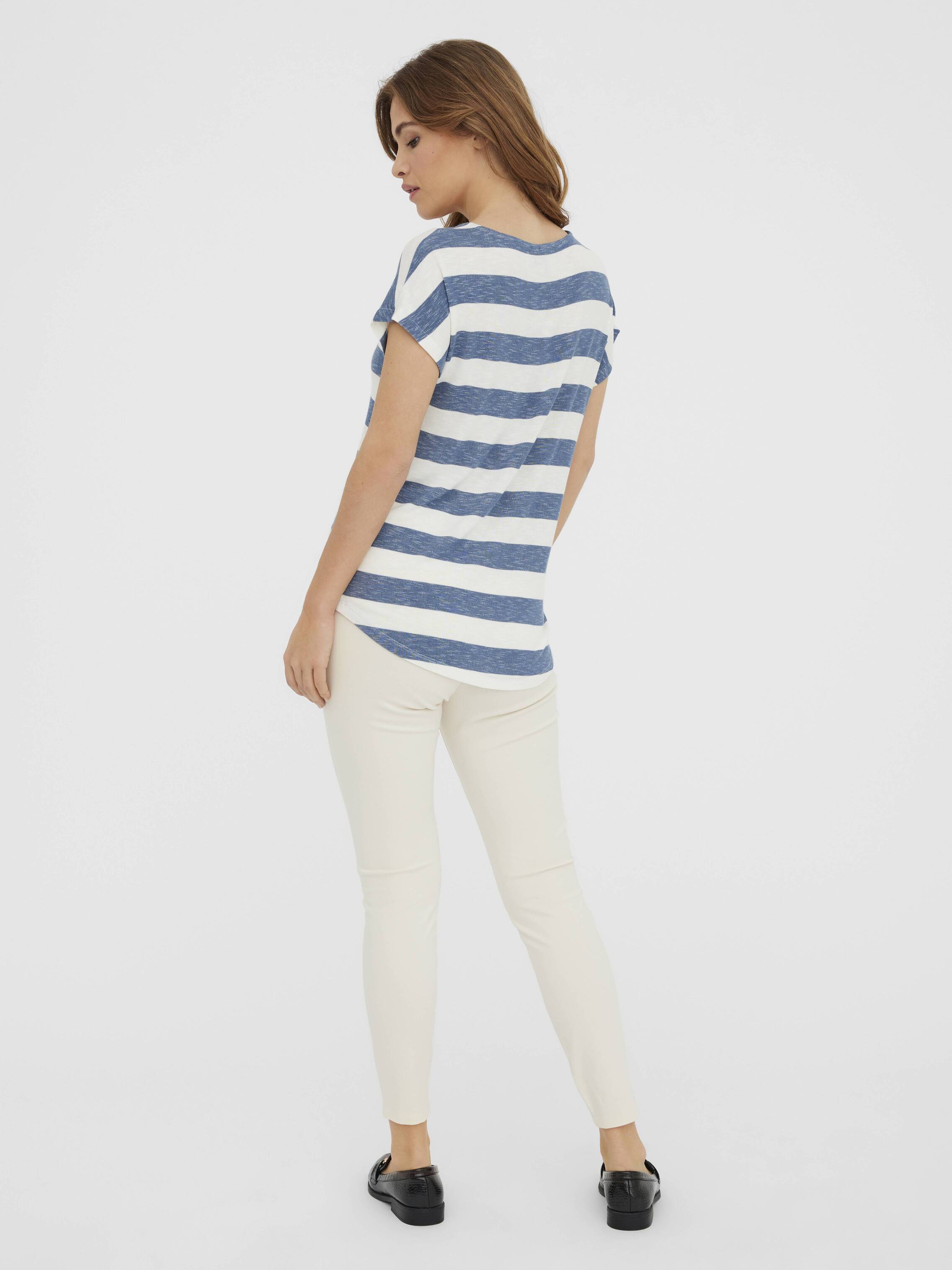 Back view of a model in casual striped top and light pants, styled simply with black loafers, complementing Vero Moda Wide Strap Fitted Top.
