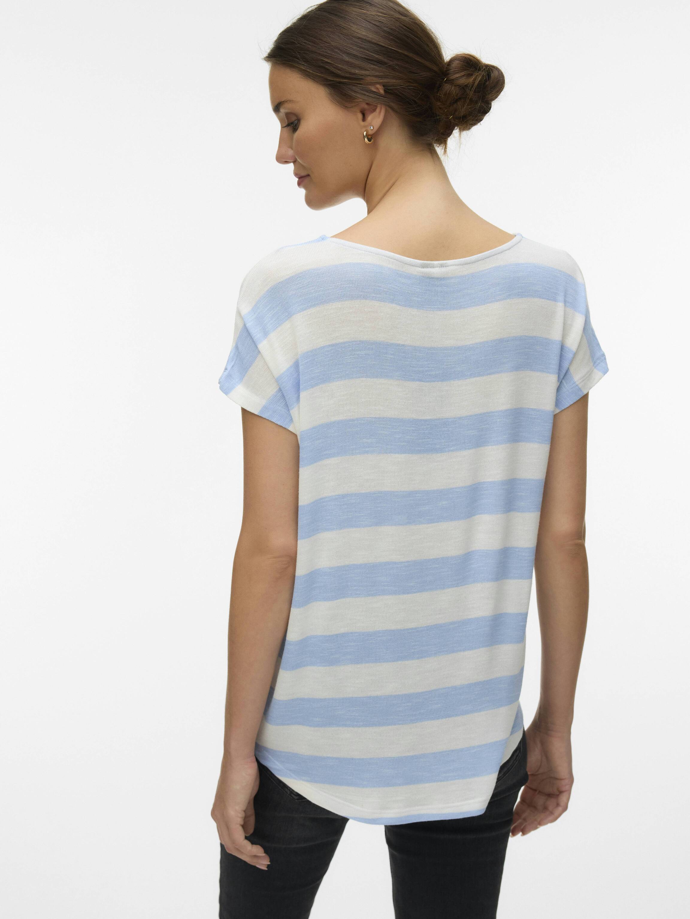 Person seen from the back wearing a light blue and white striped short sleeve top with black pants