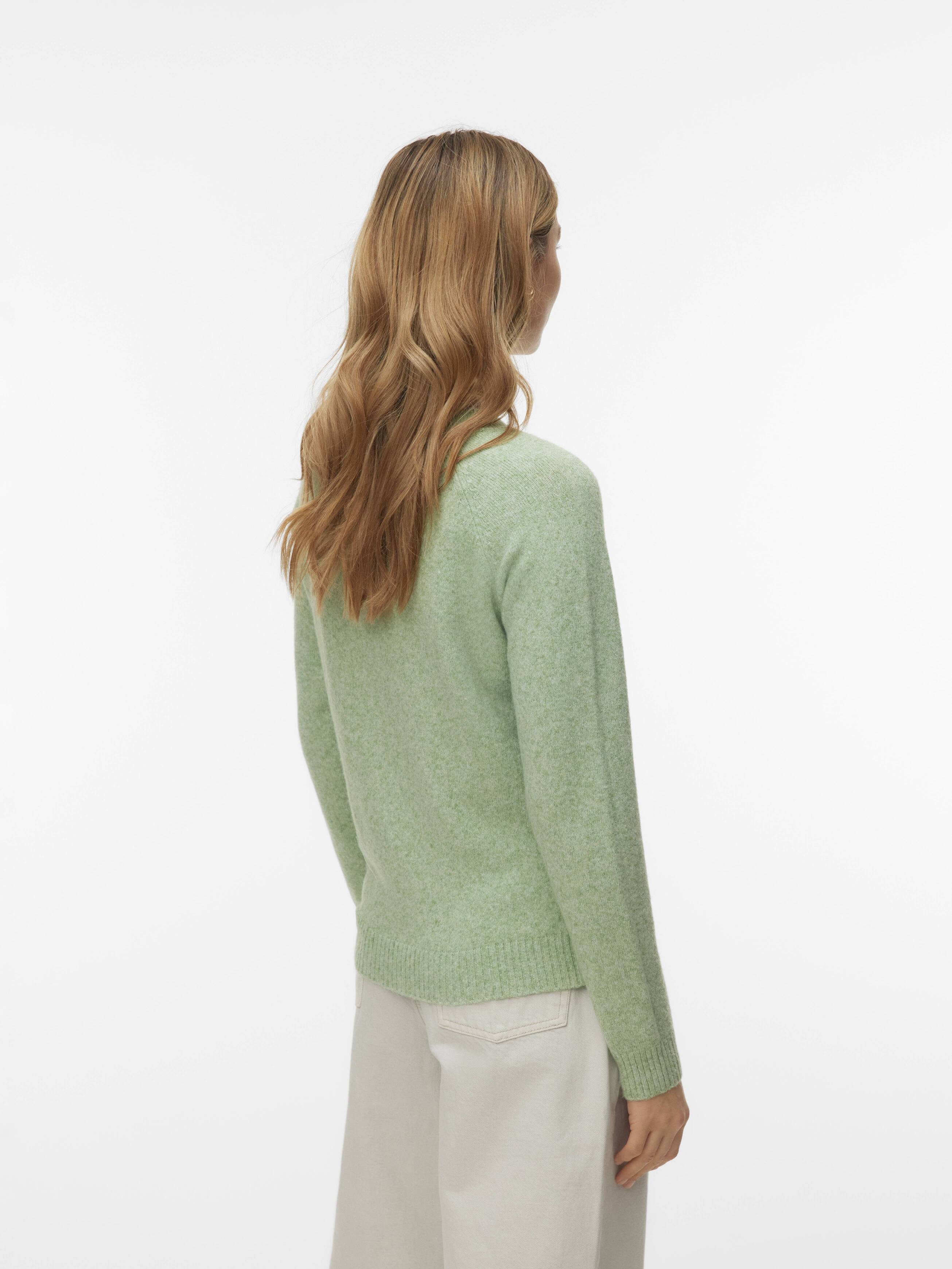 Back view of a light green Vero Moda Softy Crew Neck Lightweight Sweater paired with light pants on a model.