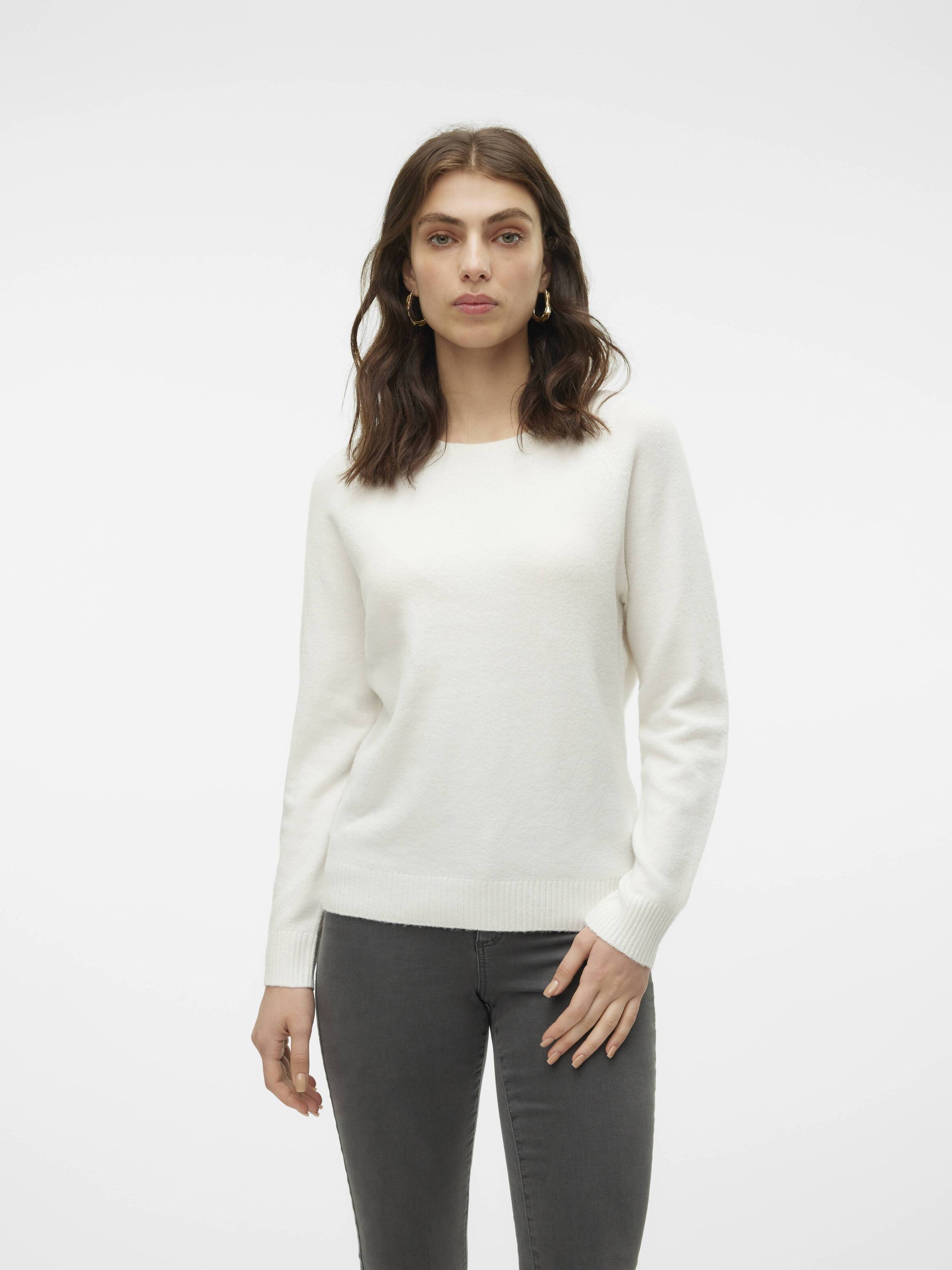 Vero Moda Softy Crew Neck Lightweight Sweater in white, styled with dark gray pants, featuring a simple, clean design.