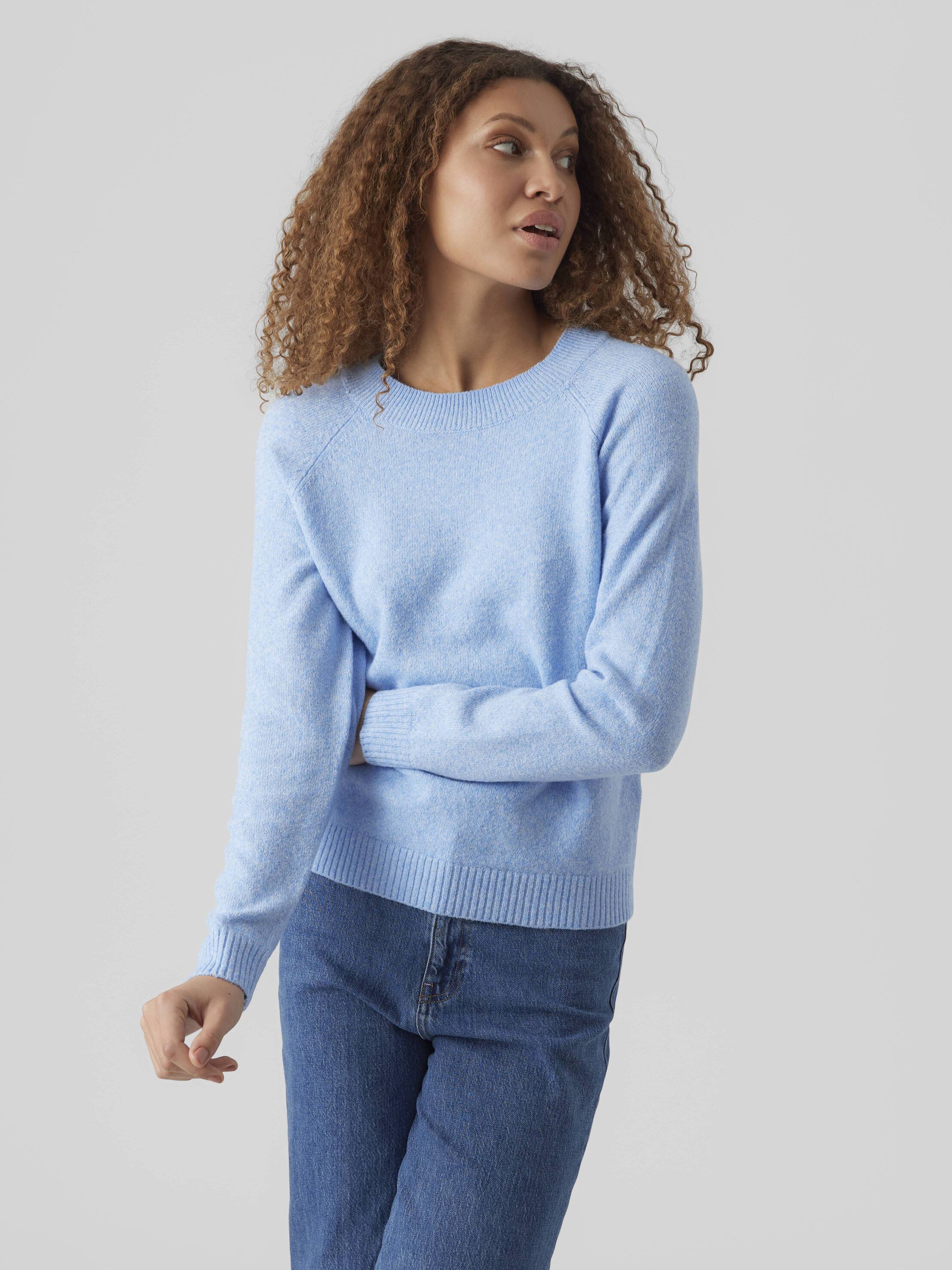 Light blue Vero Moda Softy Crew Neck Knit Sweater paired with casual denim jeans in a simple studio setting