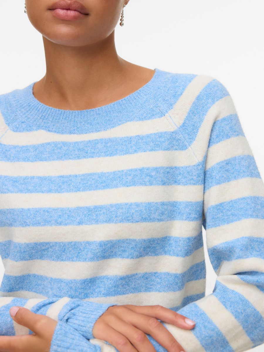 Close-up of a light blue and cream striped crew neck sweater with long sleeves on a model.