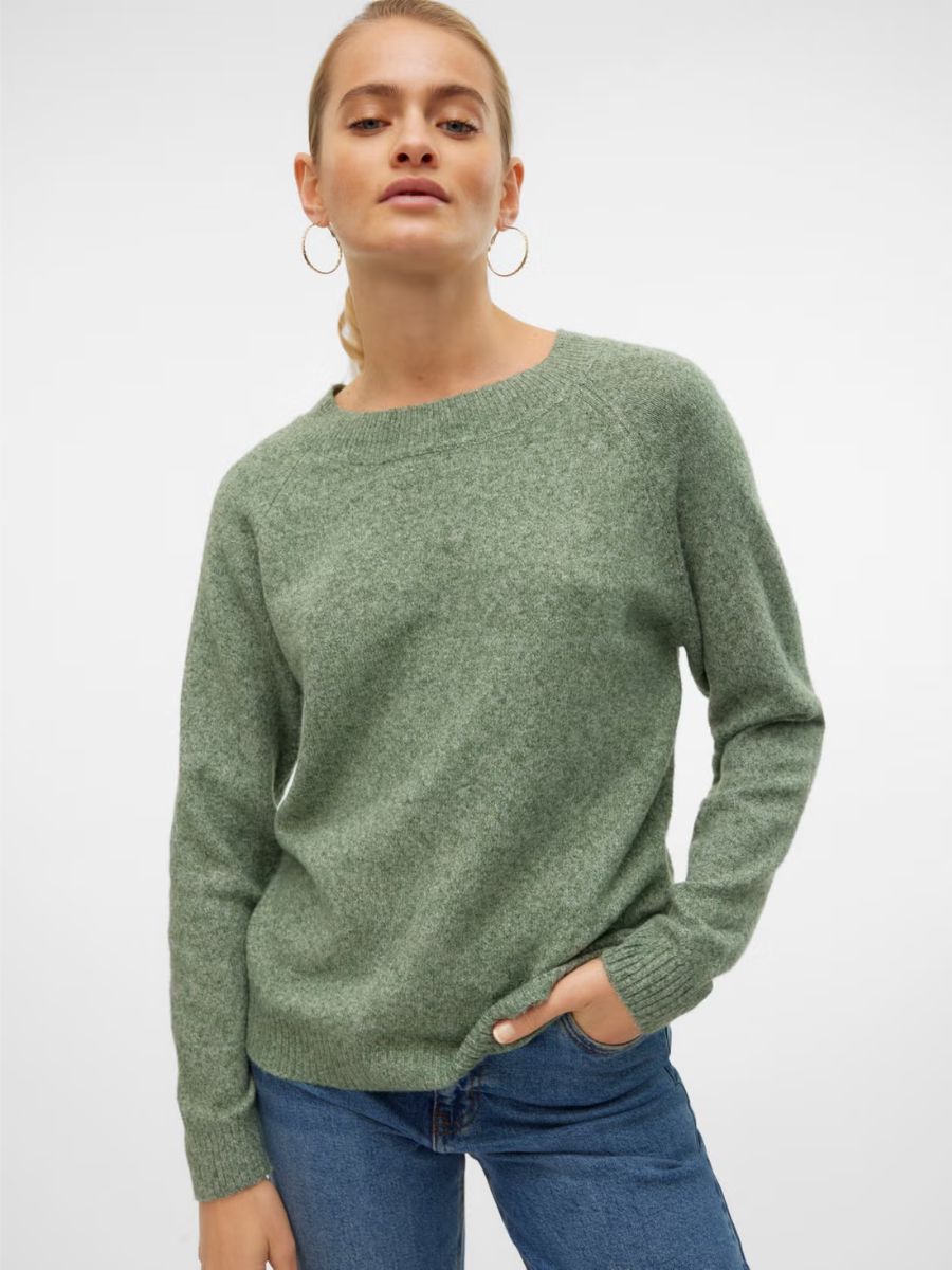 Light green knit sweater paired with blue denim jeans against a plain white background.
