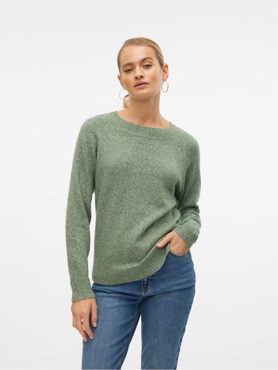 Light green knitted Vero Moda Doffy Crew Neck Knit Sweater paired with blue denim jeans, styled simply and elegantly.
