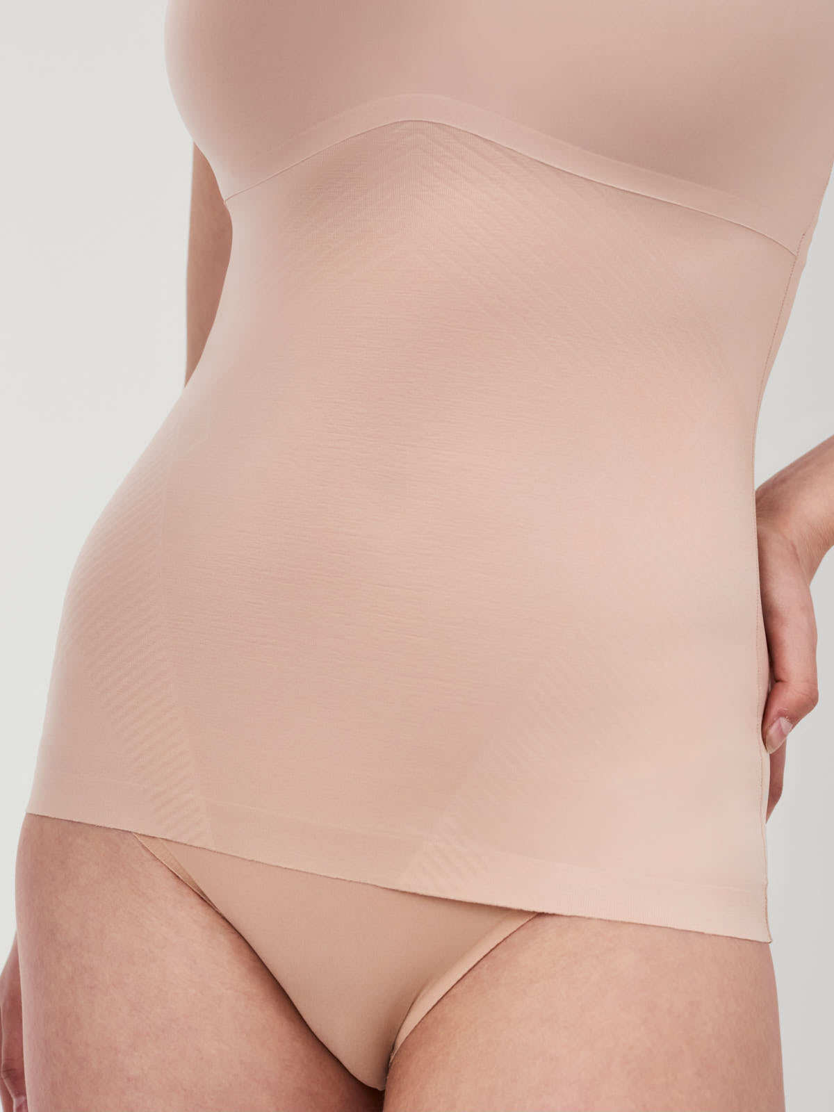 Close-up of beige SPANX Thinstincts® 2.0 Shaping Tank by Spanx designed for smooth shaping and comfort.