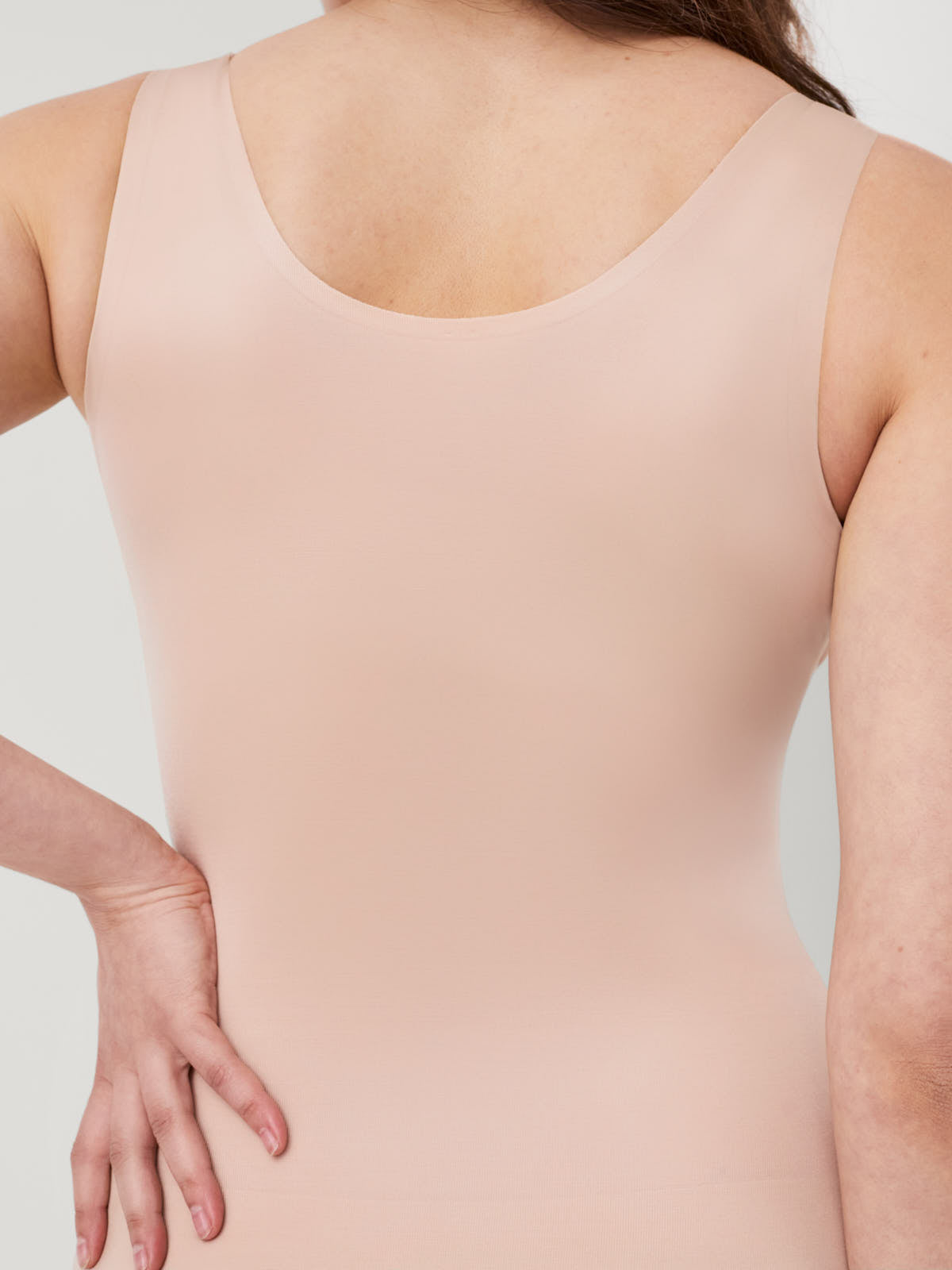 Back view of light beige SPANX Thinstincts® 2.0 Shaping Tank by Spanx, smooth seamless fabric top