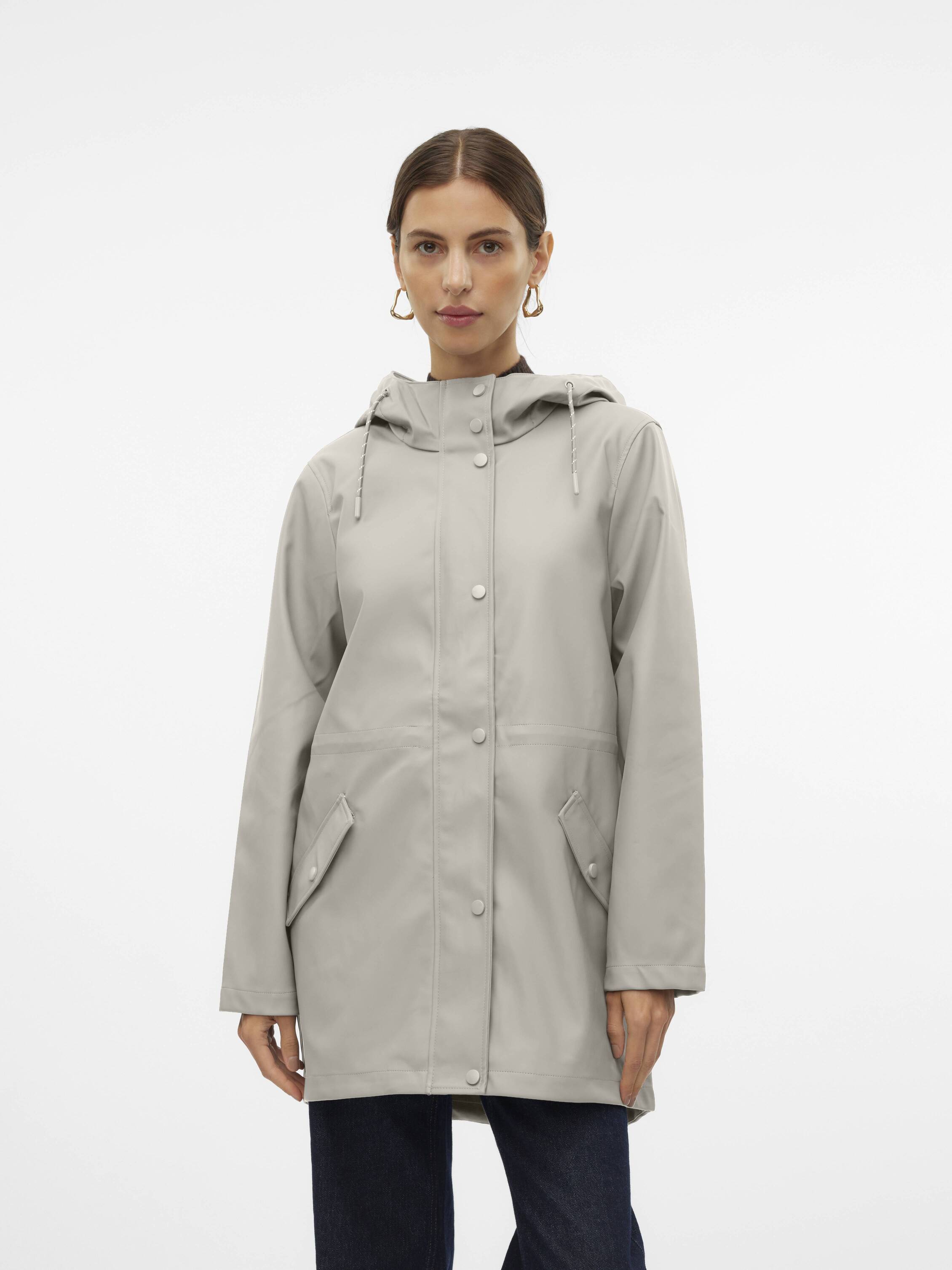 Light beige hooded raincoat with snap buttons and front flap pockets on a person against a white background