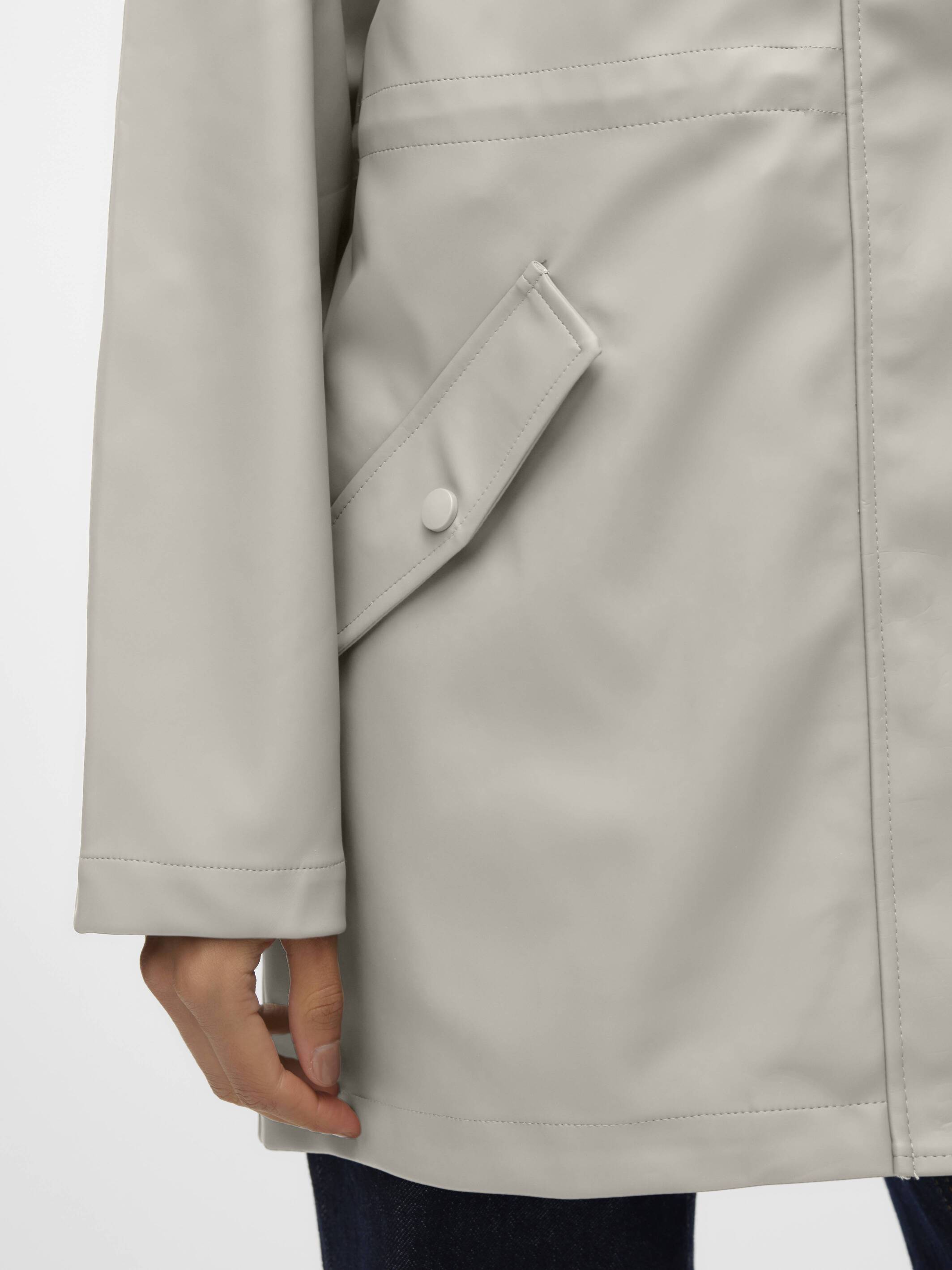 Close-up of a beige Vero Moda Malou Hooded Rain Jacket pocket and sleeve detail on outerwear jacket by Vero Moda.