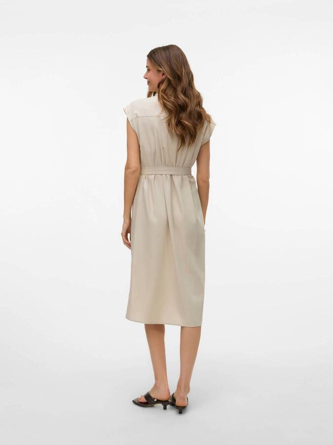 Back view of beige Vero Moda My Nen Shirt Dress with belt and cap sleeves, paired with black heeled sandals.