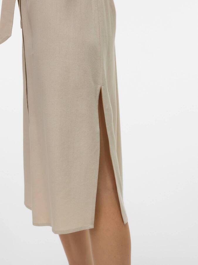 Close-up of beige fabric and side slit detail on Vero Moda My Nen Shirt Dress by Vero Moda