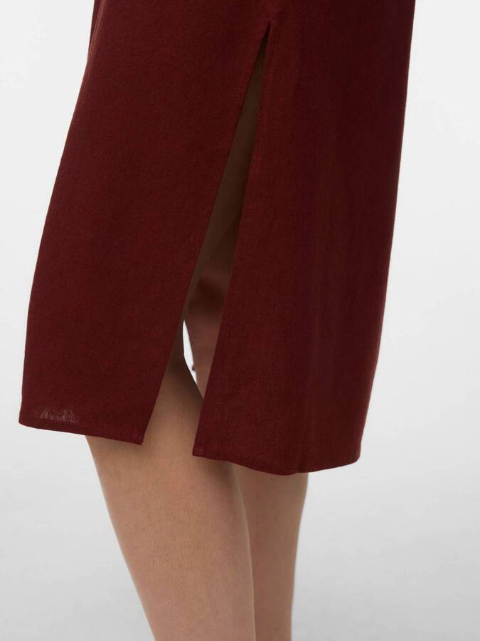 Close-up of rust-colored Vero Moda My Nen Shirt Dress hem with a side slit detail above the knee.