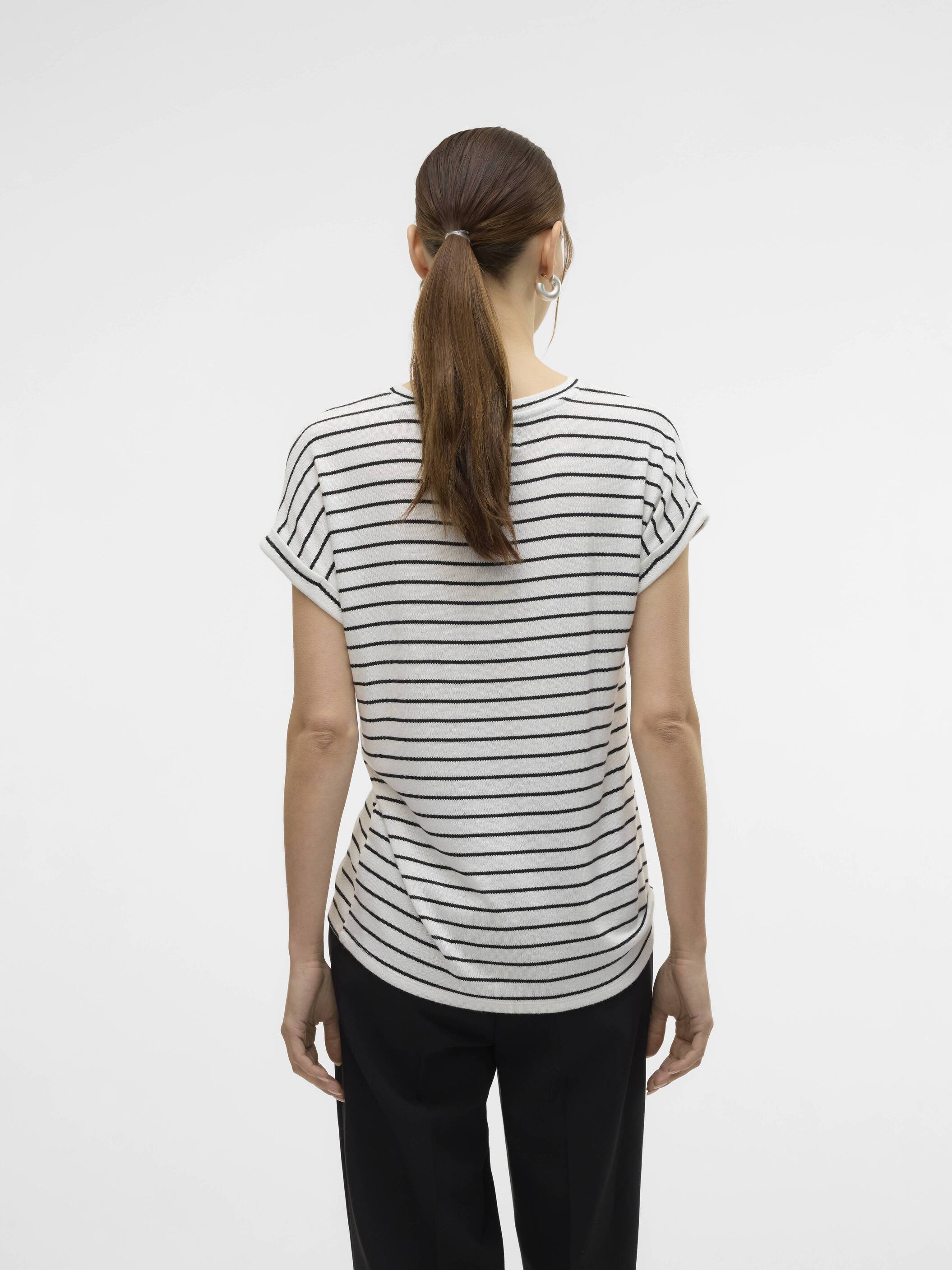 Back view of a person in a white and black horizontal striped short sleeve top and black pants against a white background.