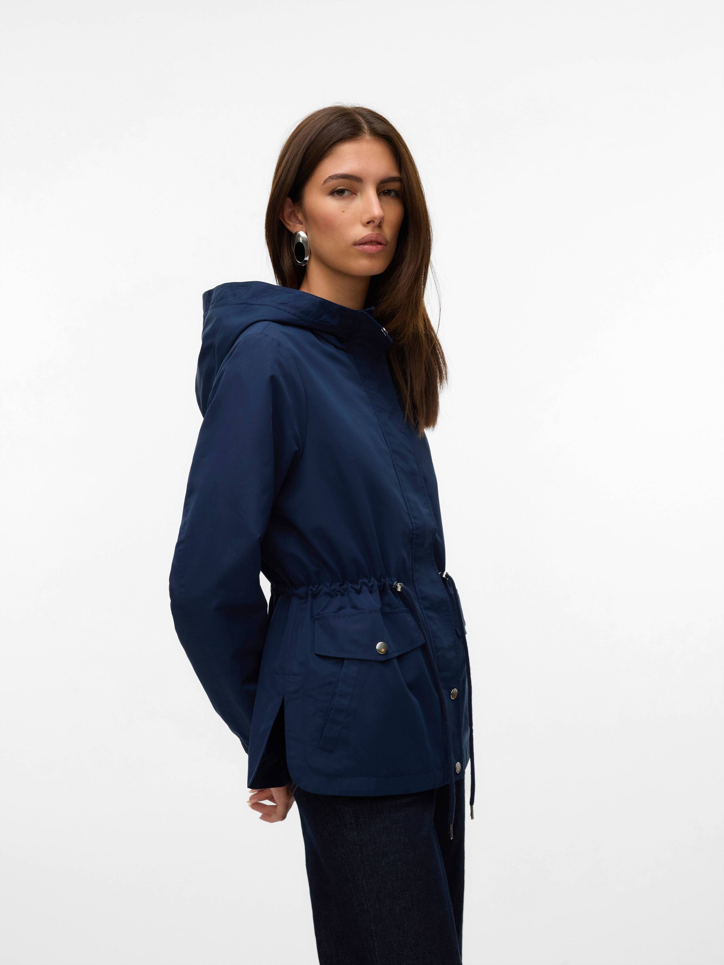 Navy blue hooded jacket with front pockets and drawstring waist worn with dark pants against white background