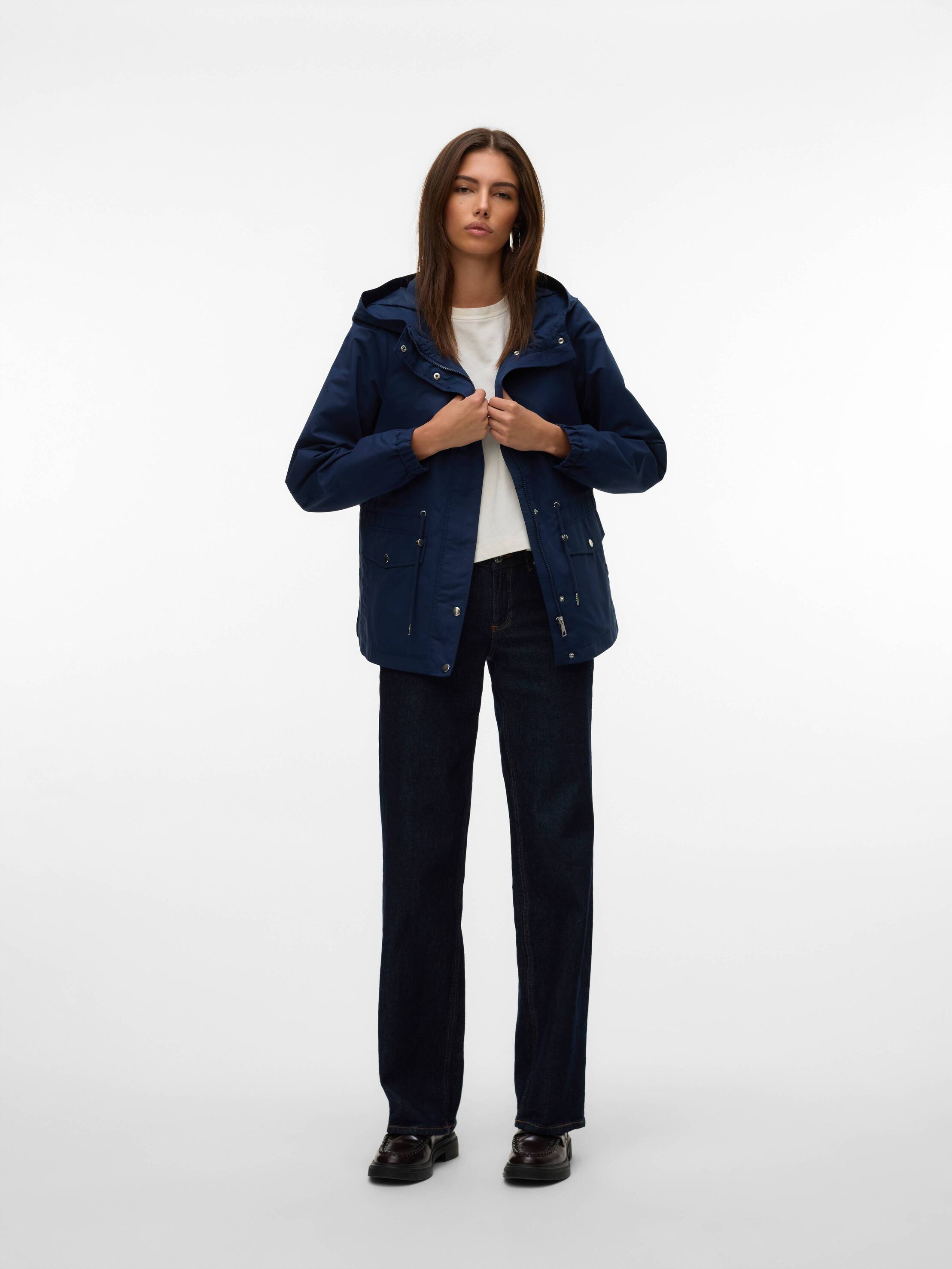 Vero Moda Drawstring Hooded Utility Jacket in navy blue styled with black pants and white top for casual outerwear look