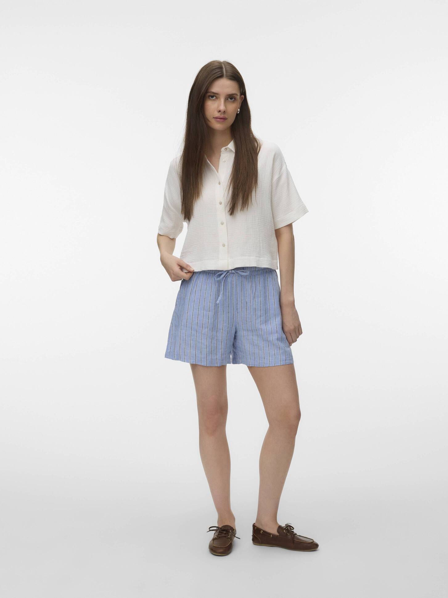 Vero Moda Linen Shorts in blue with subtle stripes, styled with a white short-sleeve shirt and brown shoes