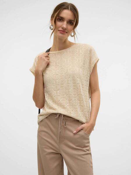 Vero Moda Mayet Short Sleeve Top in beige lace pattern paired with light brown pants, styled with earrings, from Vero Moda.