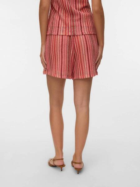 Back view of Vero Moda Demet High-Waist Shorts in coral striped fabric paired with matching top and sandals.