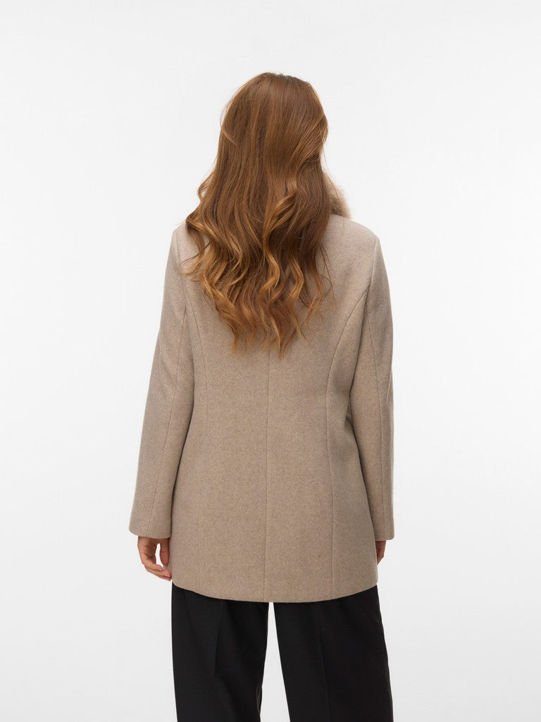 Back view of a figure in a beige coat with black trousers against a white background.