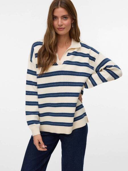 Model wearing a cream and navy striped Vero Moda Gol Polo Shirt with long sleeves and collar, paired with dark denim pants