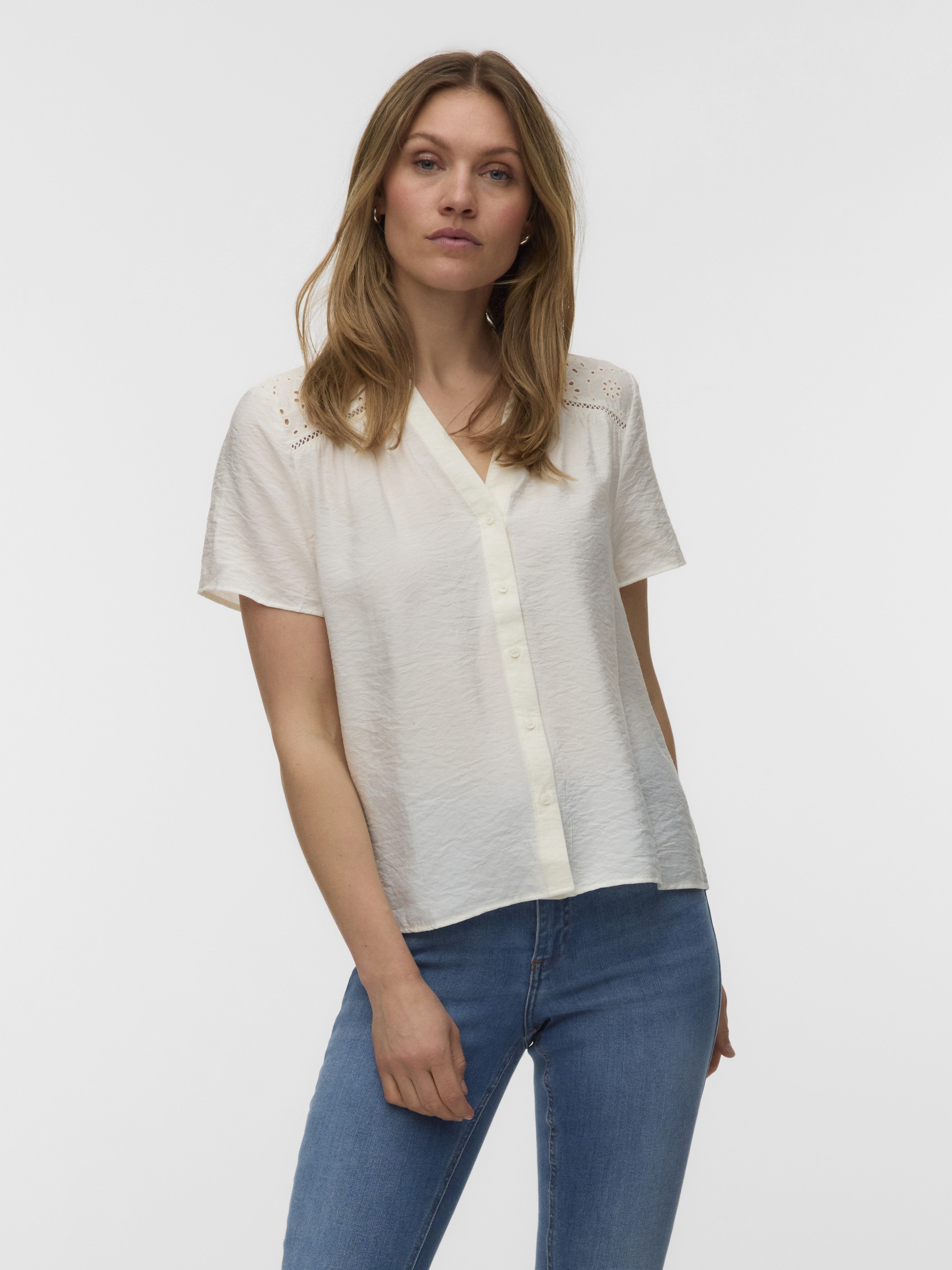 Light cream Vero Moda Josv Knit Short Sleeve Top paired with blue denim jeans on a plain background