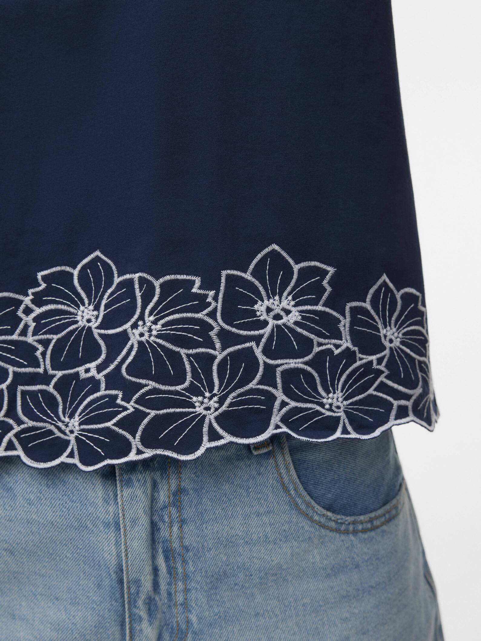 Vero Moda Noah Embroidered Short Sleeve Top in navy with floral embroidery detail paired with denim jeans.
