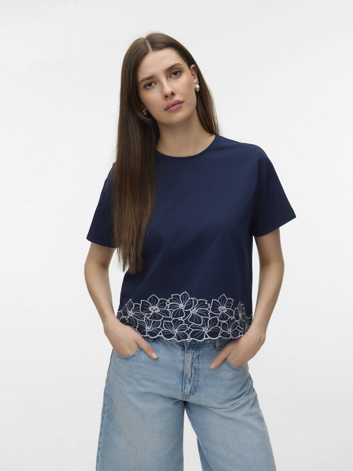 Vero Moda Noah Embroidered Short Sleeve Top in navy with floral embroidery paired with casual light blue denim jeans