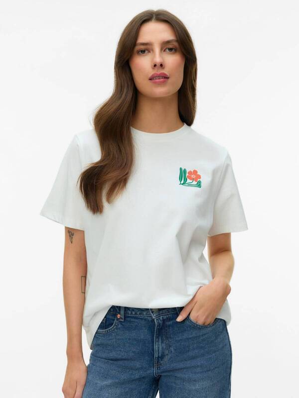 Vero Moda Maja Flower Bustier Top displayed in white with floral detail, styled with blue denim jeans by Vero Moda
