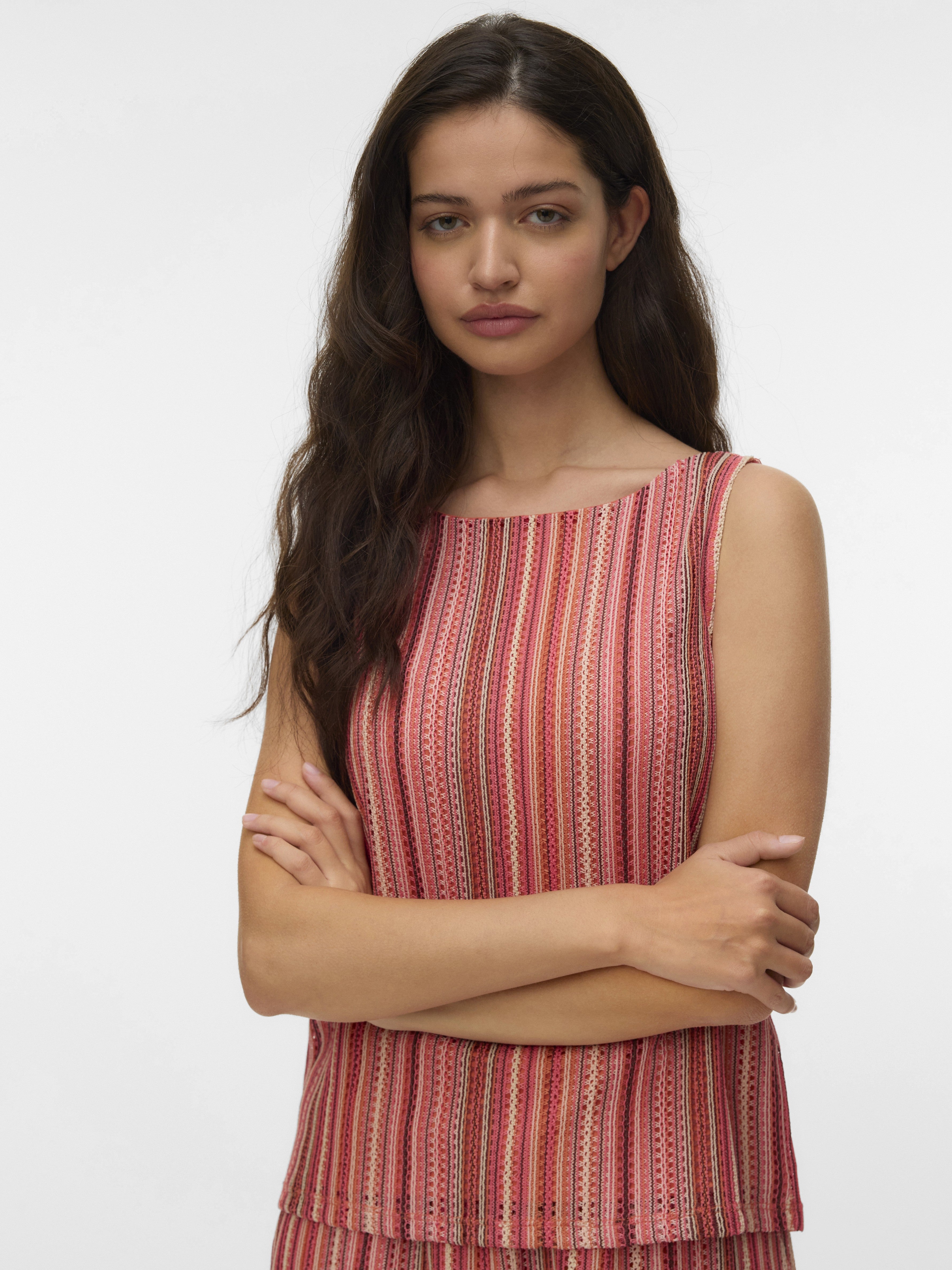 Sleeveless top with vertical stripes in coral, pink, and beige tones on a model with long dark hair.