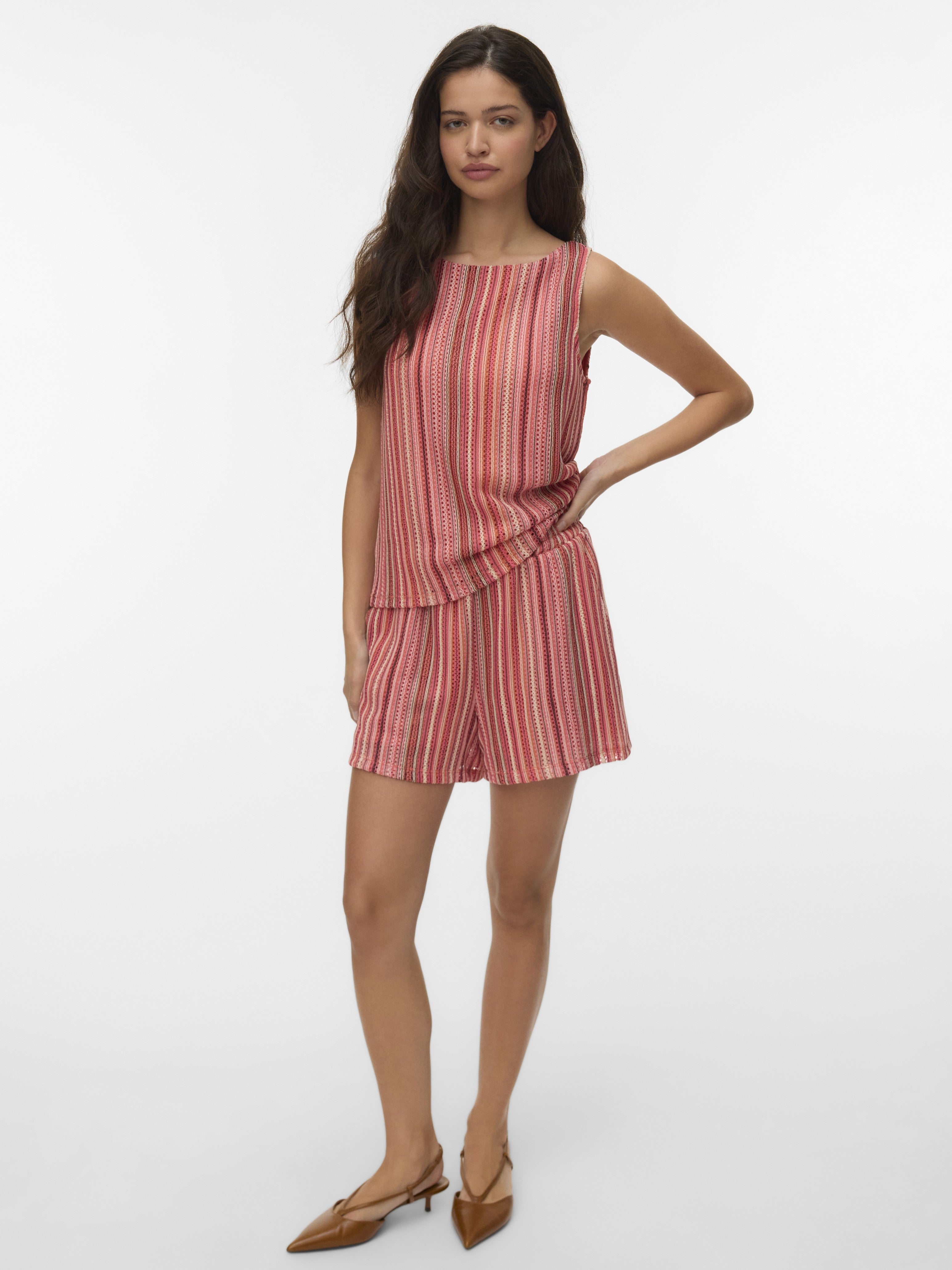 Sleeveless coral and red striped top paired with matching loose shorts and brown pointed flat shoes on model.