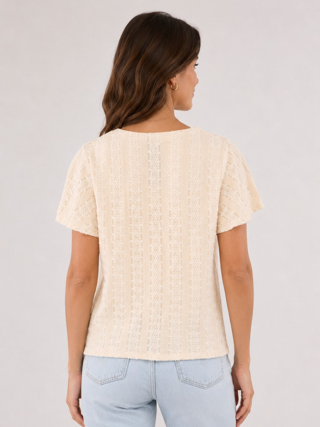 Vero Moda Cassandra Eyelet Short Sleeve Top in beige eyelet fabric, shown from the back with light texture detailing.