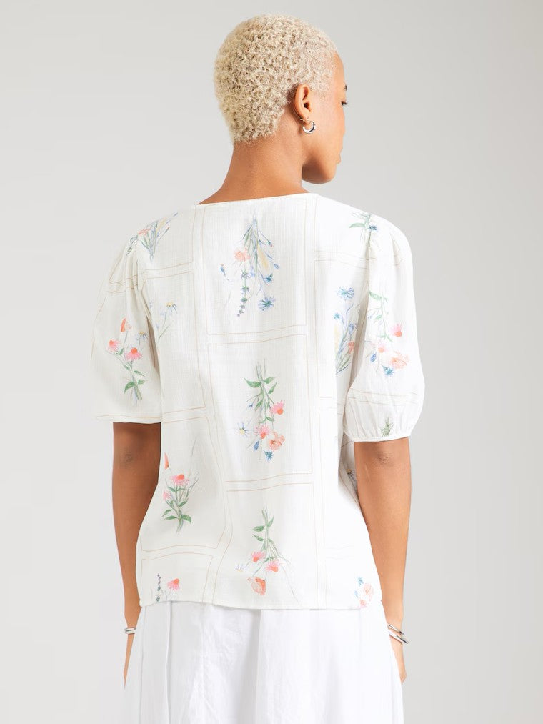 Back view of a white short-sleeve top with a delicate floral print and puff sleeves.