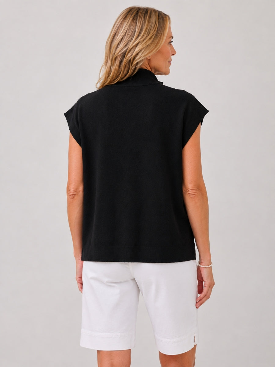 Back view of a sleeveless black top paired with white knee-length shorts against a plain background.