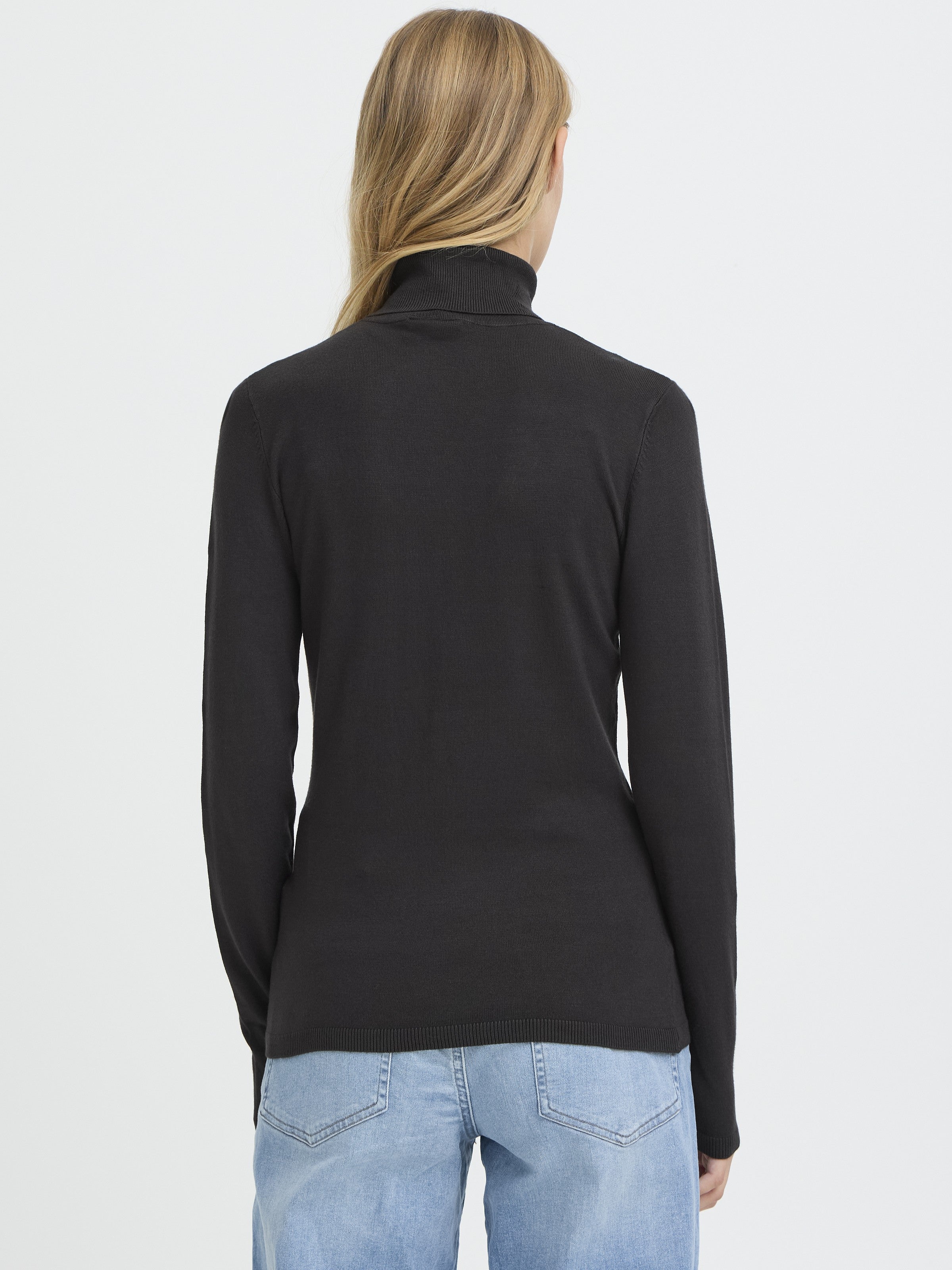 Black Ichi Mafa Turtleneck Sweater in soft fabric, styled with light denim jeans, ideal for layering and warmth.