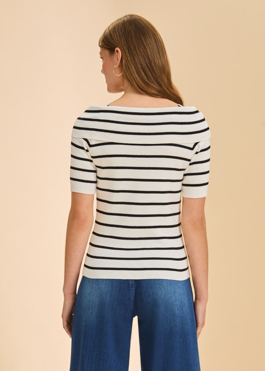 Back view of a white short-sleeve sweater with black horizontal stripes and blue denim pants.