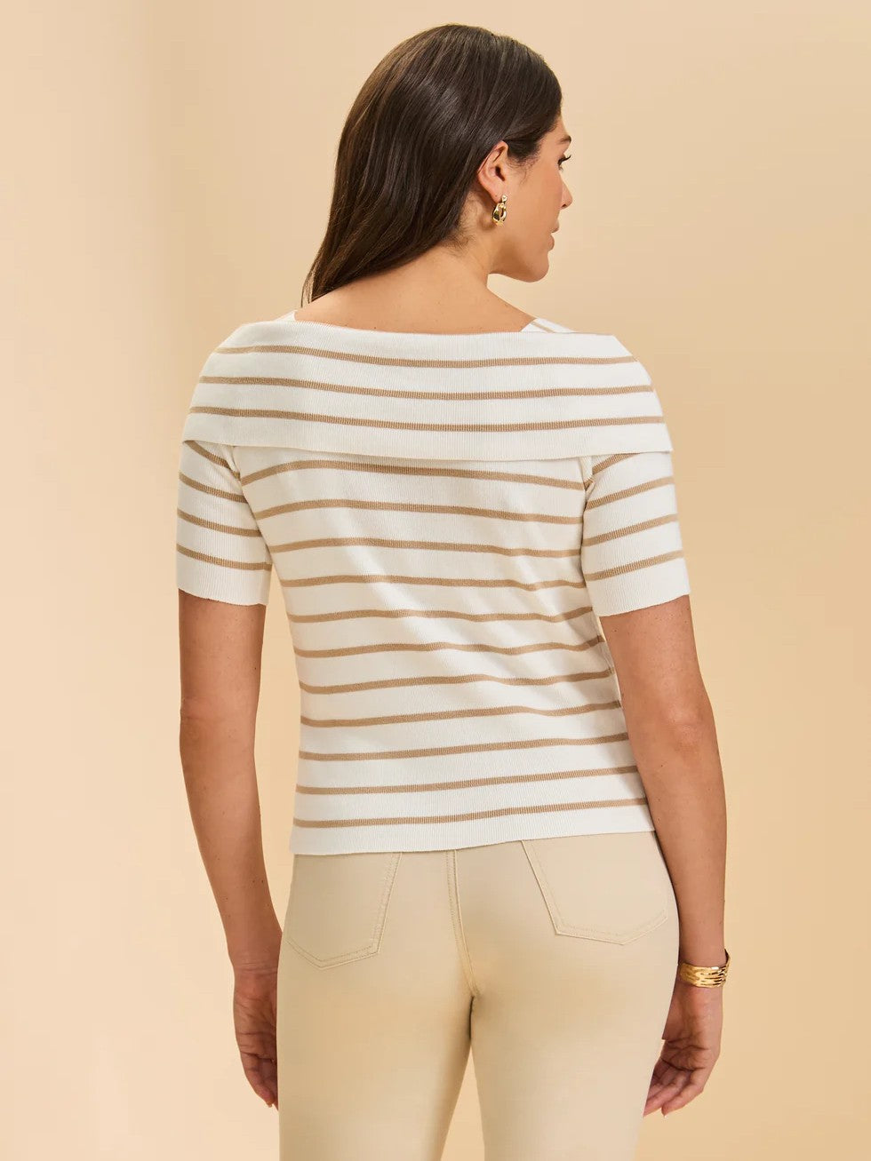 Back view of a short-sleeve white top with horizontal beige stripes paired with beige pants on a neutral background.