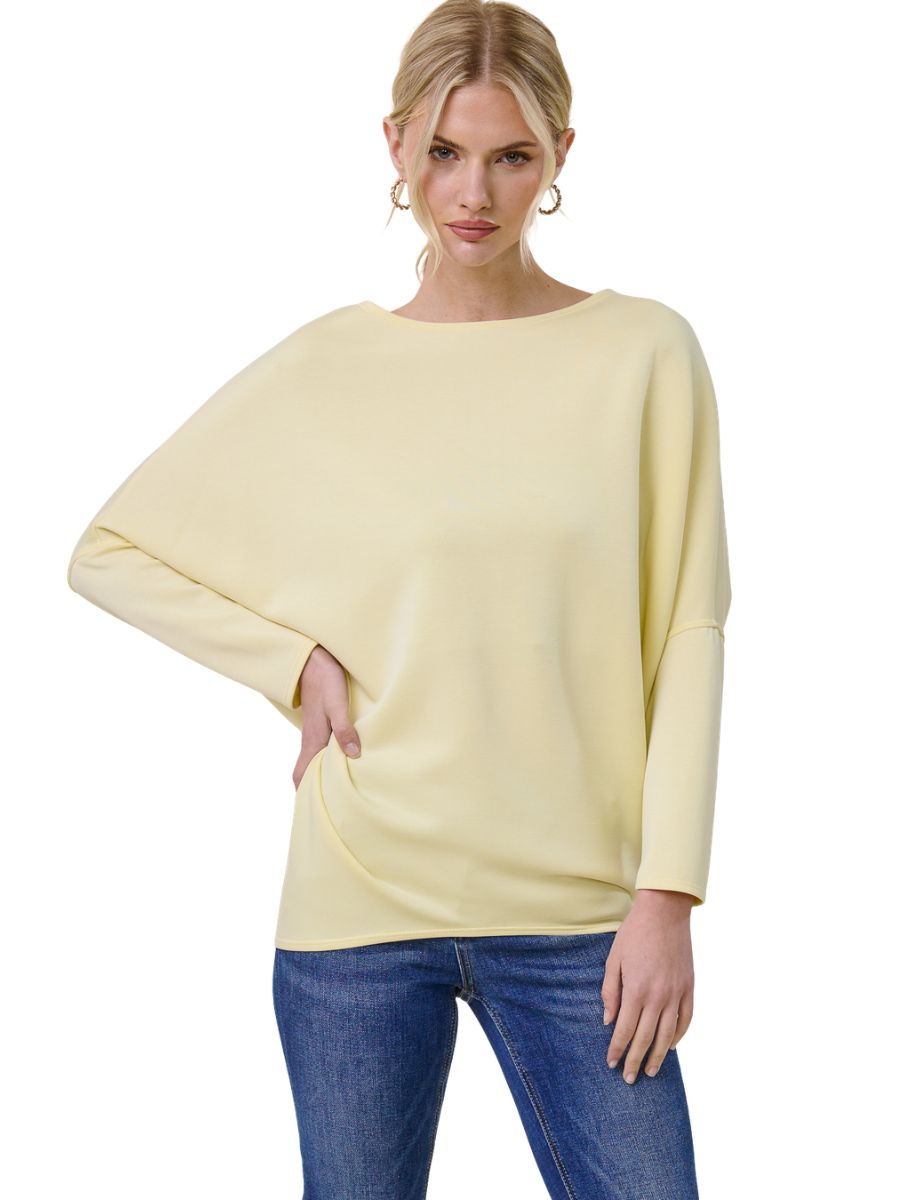 Light yellow Julie Modal Dolman Top from Jolie Inc., styled with blue denim jeans for a casual look.