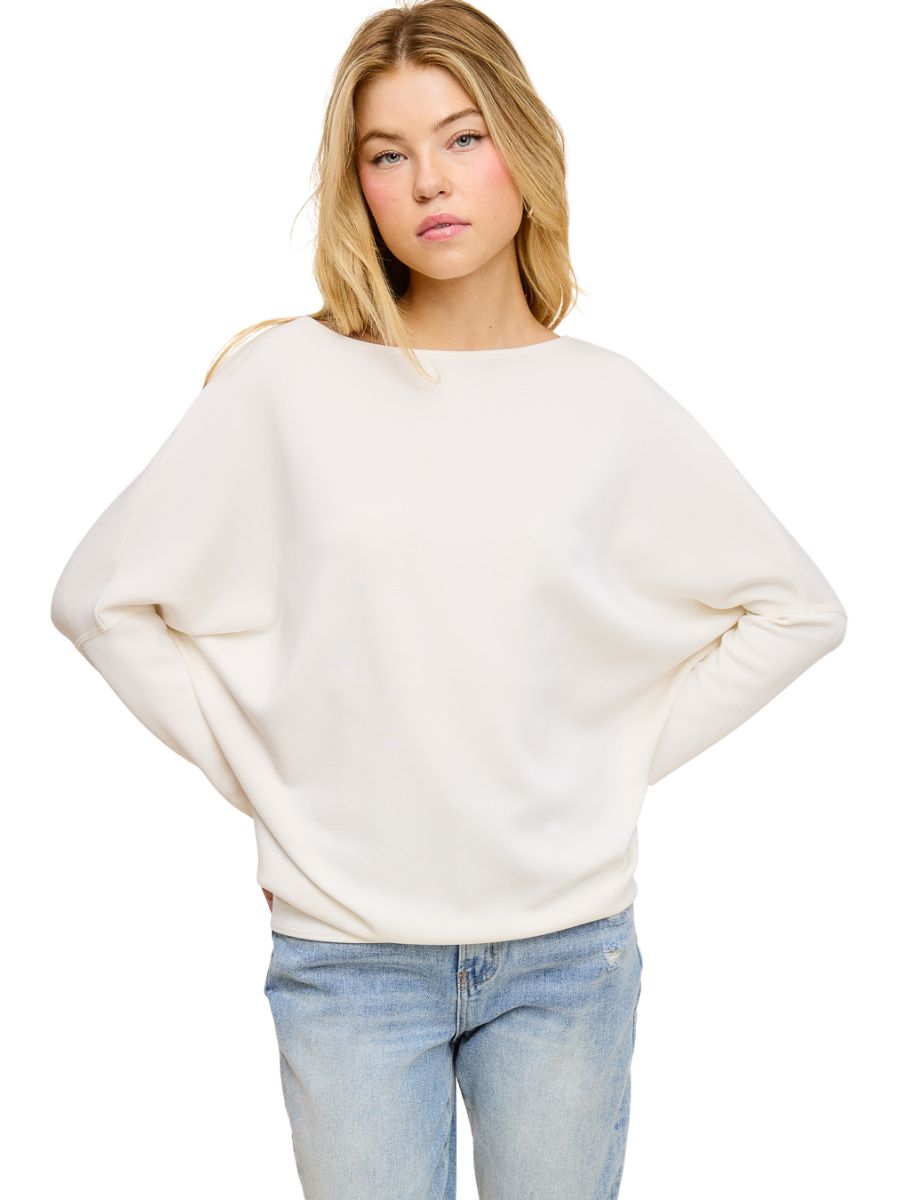 Off-white Julie Modal Dolman Top from Jolie Inc. styled with light blue denim jeans, casual loose fit garment.