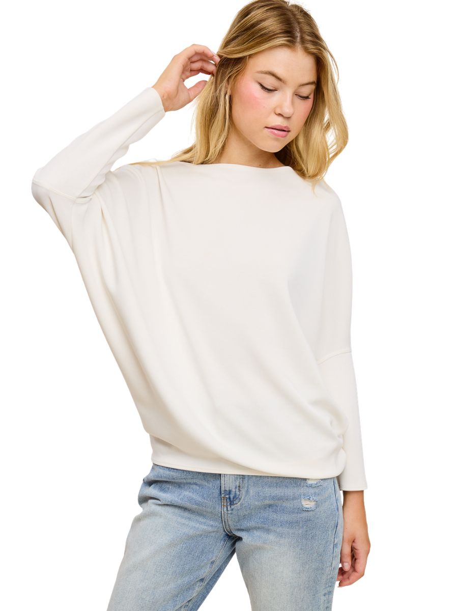 Off-white Julie Modal Dolman Top by Jolie Inc. styled with casual light denim jeans and long sleeves.
