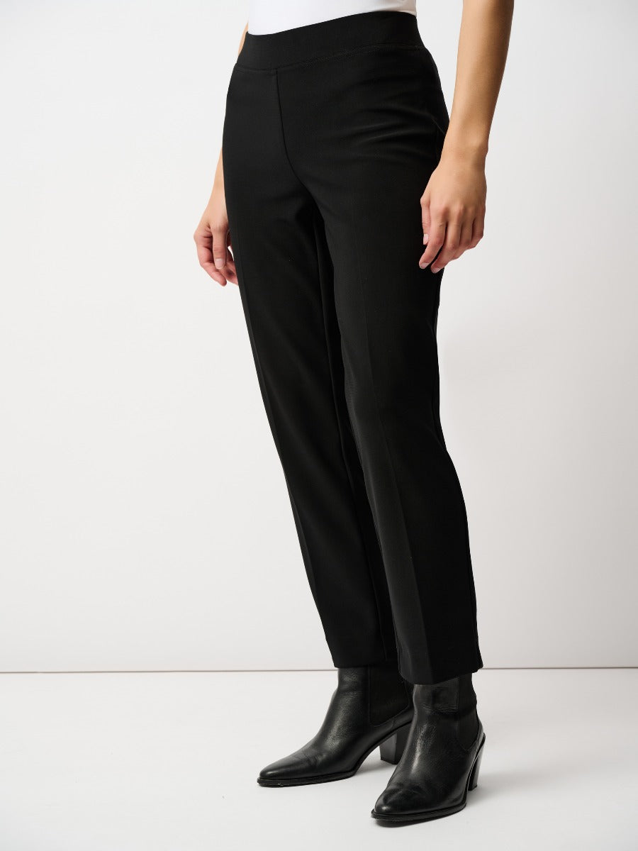 Black straight-leg pants paired with black ankle boots against a plain white background.