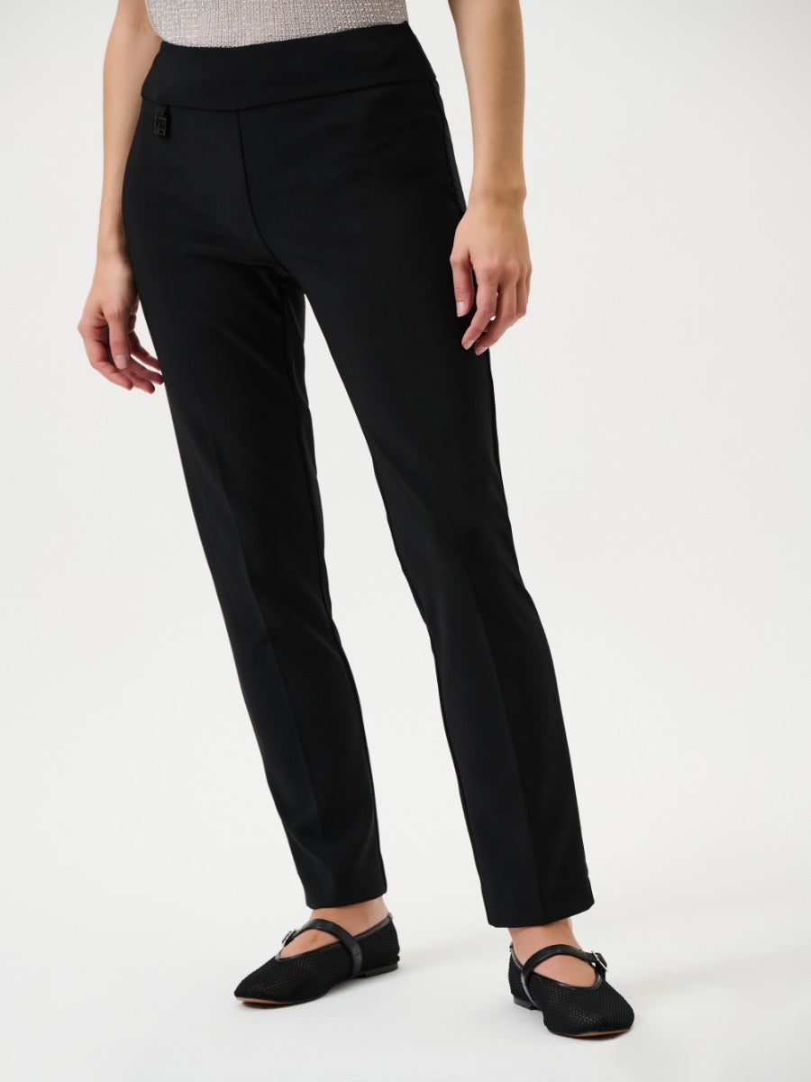Black slim leg pants by Joseph Ribkoff with a pull-on design, styled with black Mary Jane flats.