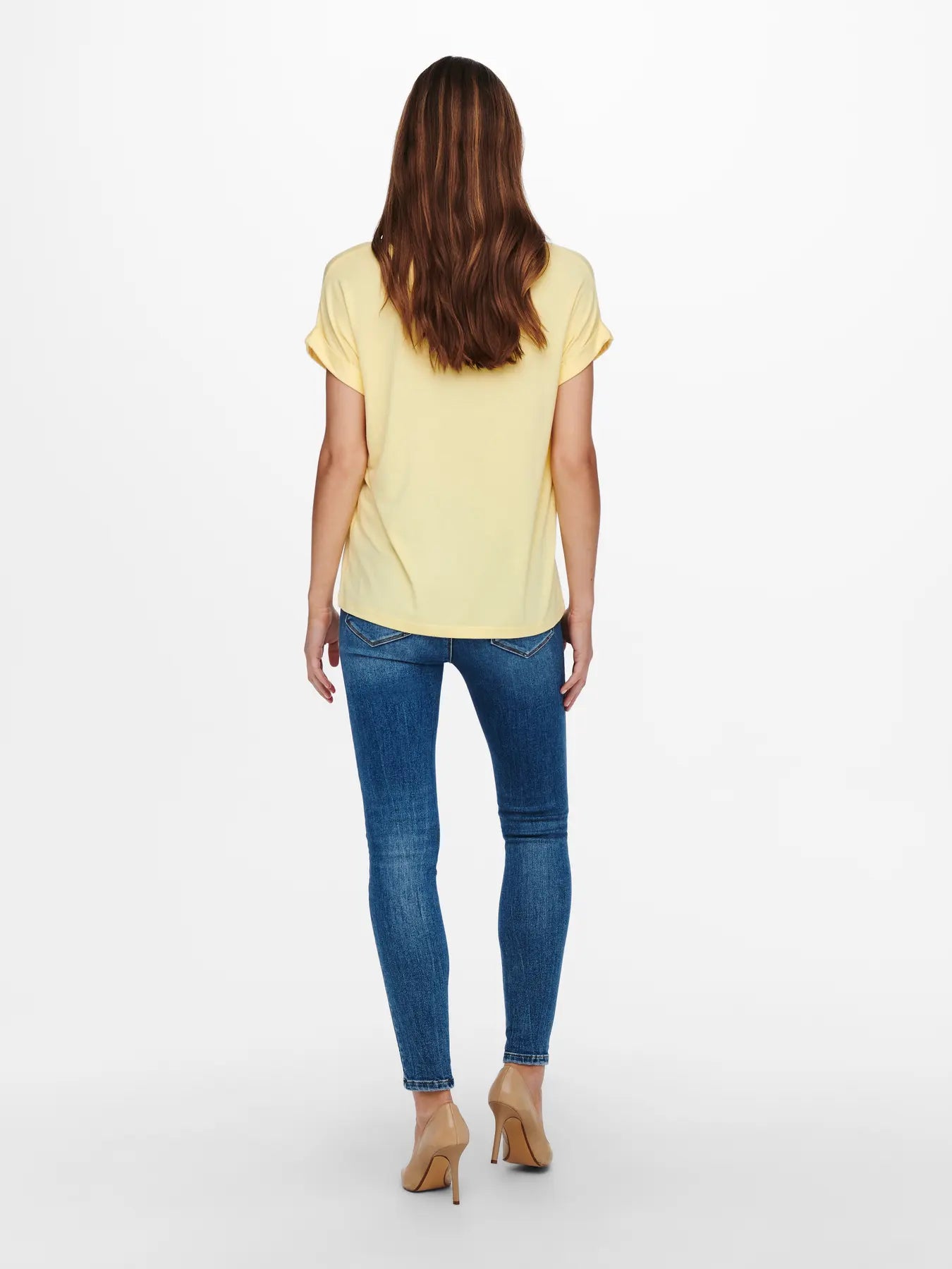 ONLY Moster Short Sleeve Crew Tee by Only in soft yellow paired with blue denim jeans and beige heels viewed from the back