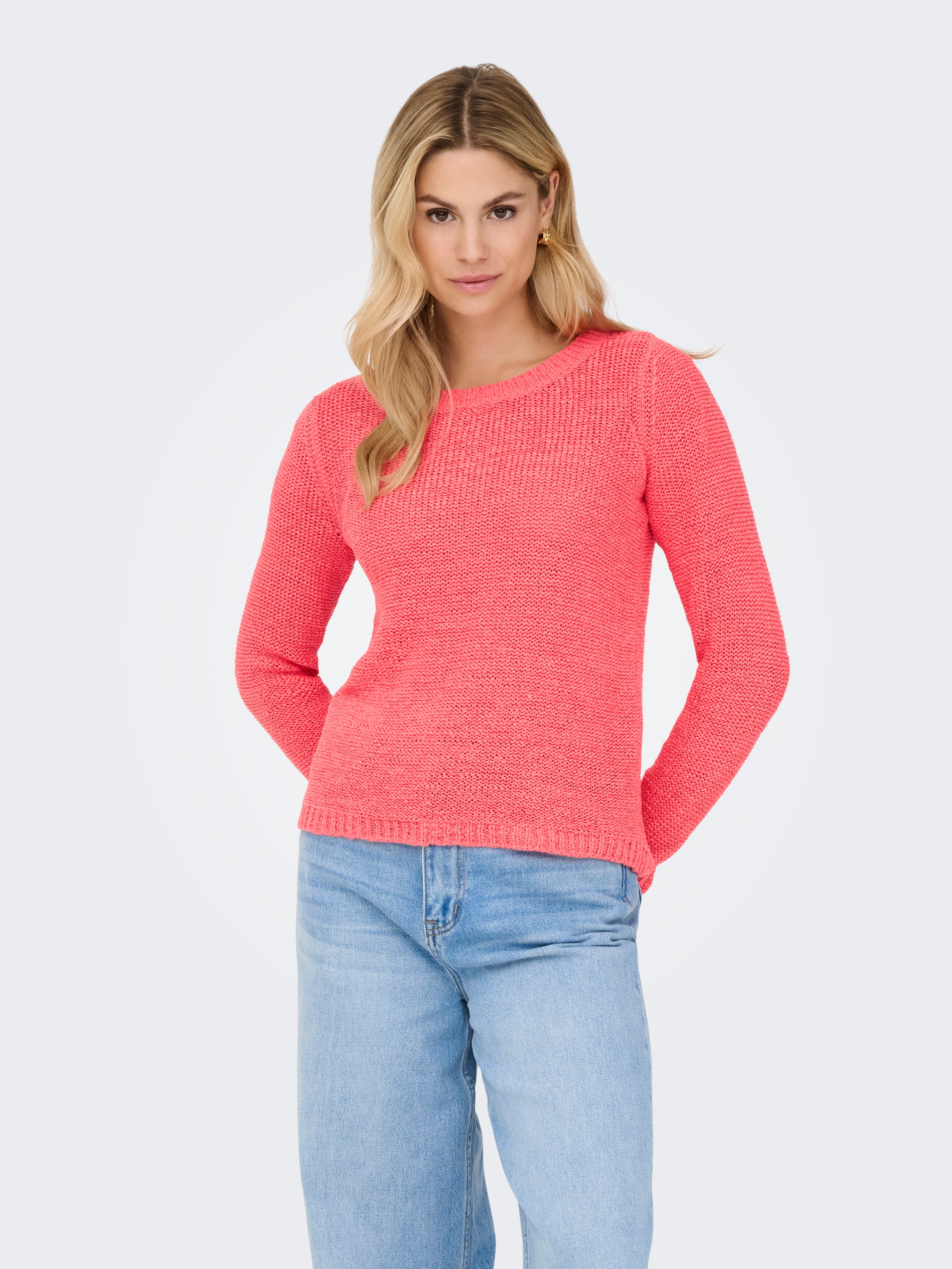 ONLY Geena Loose Knit Crew Sweater in coral pink, styled with light blue denim jeans by Only, casual knitwear top.