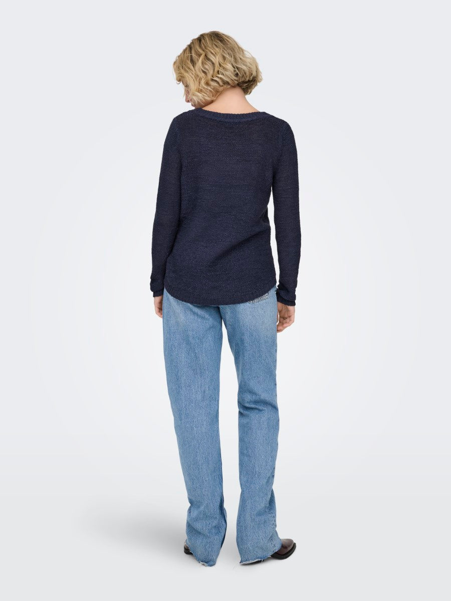 Back view of a navy sweater styled with light denim jeans in an Only outfit featuring ONLY Geena Loose Knit Crew Sweater