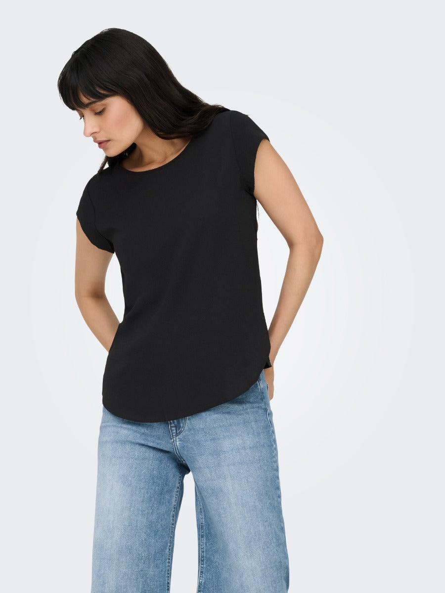 Black short sleeve casual top paired with light blue denim jeans, ONLY Vic Solid Top by Only brand.